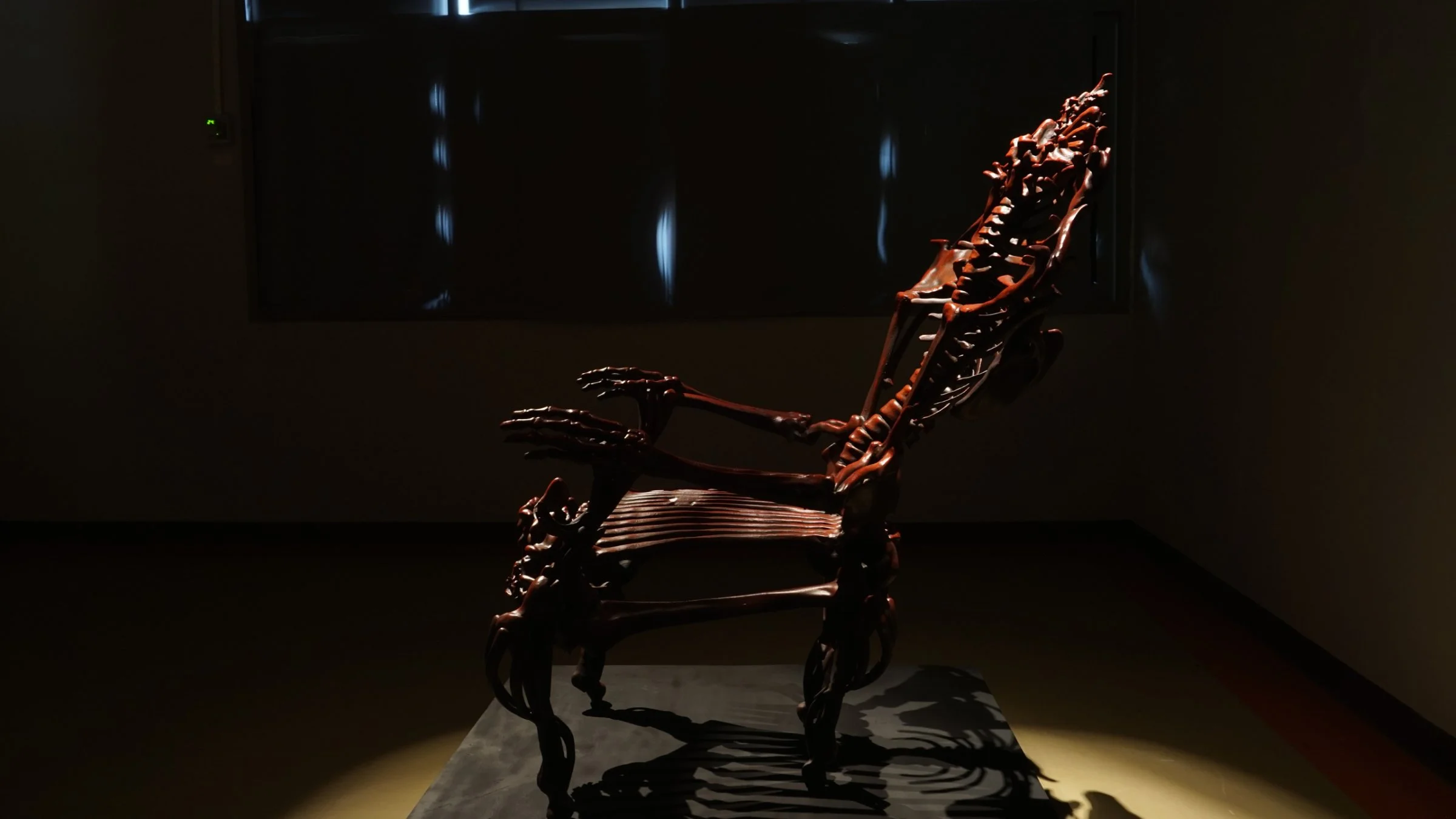 Side view of Bloody Chair by Ratthakorn Disjaiyen - Red hand-painted acrylic on fiberglass resin