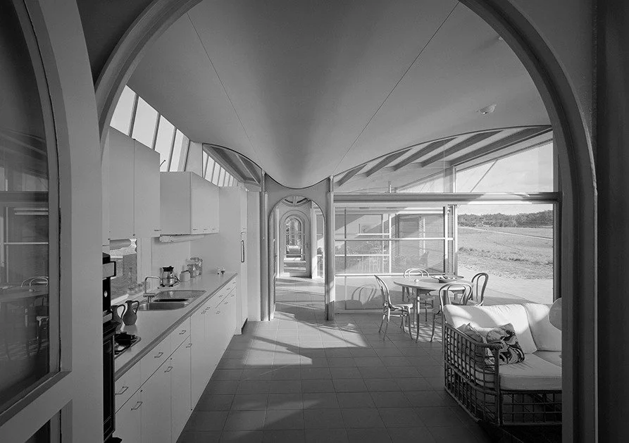 Deep eaves framing direct sunlight into an interior living space