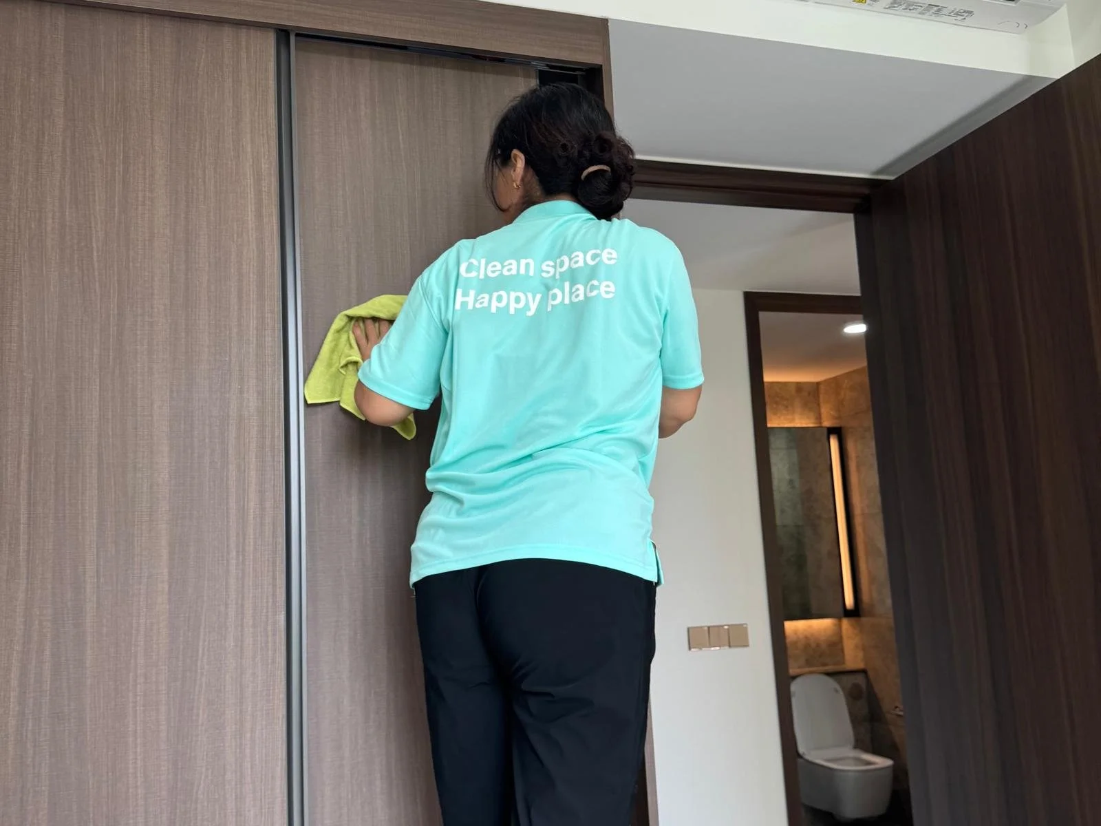 Cleanova Pte Ltd staff cleaning the wardrobe.