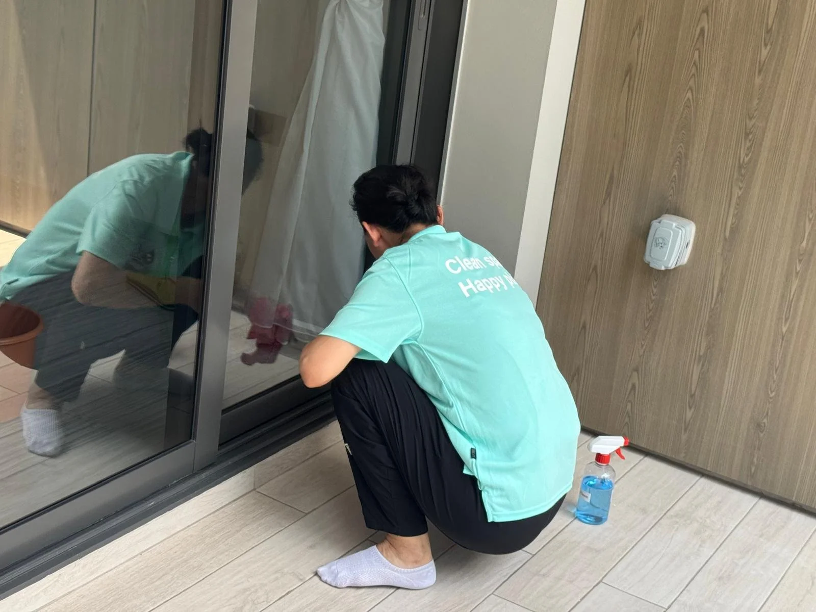 Cleanova Pte Ltd staff cleaning the window tracks.