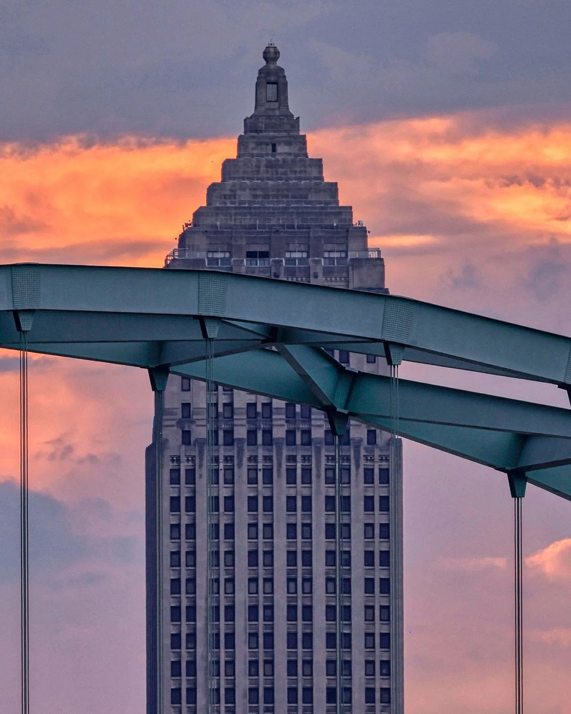 The Gulf Building against a colorful sunset sky with the Birmingham 
bridge in the foreground.