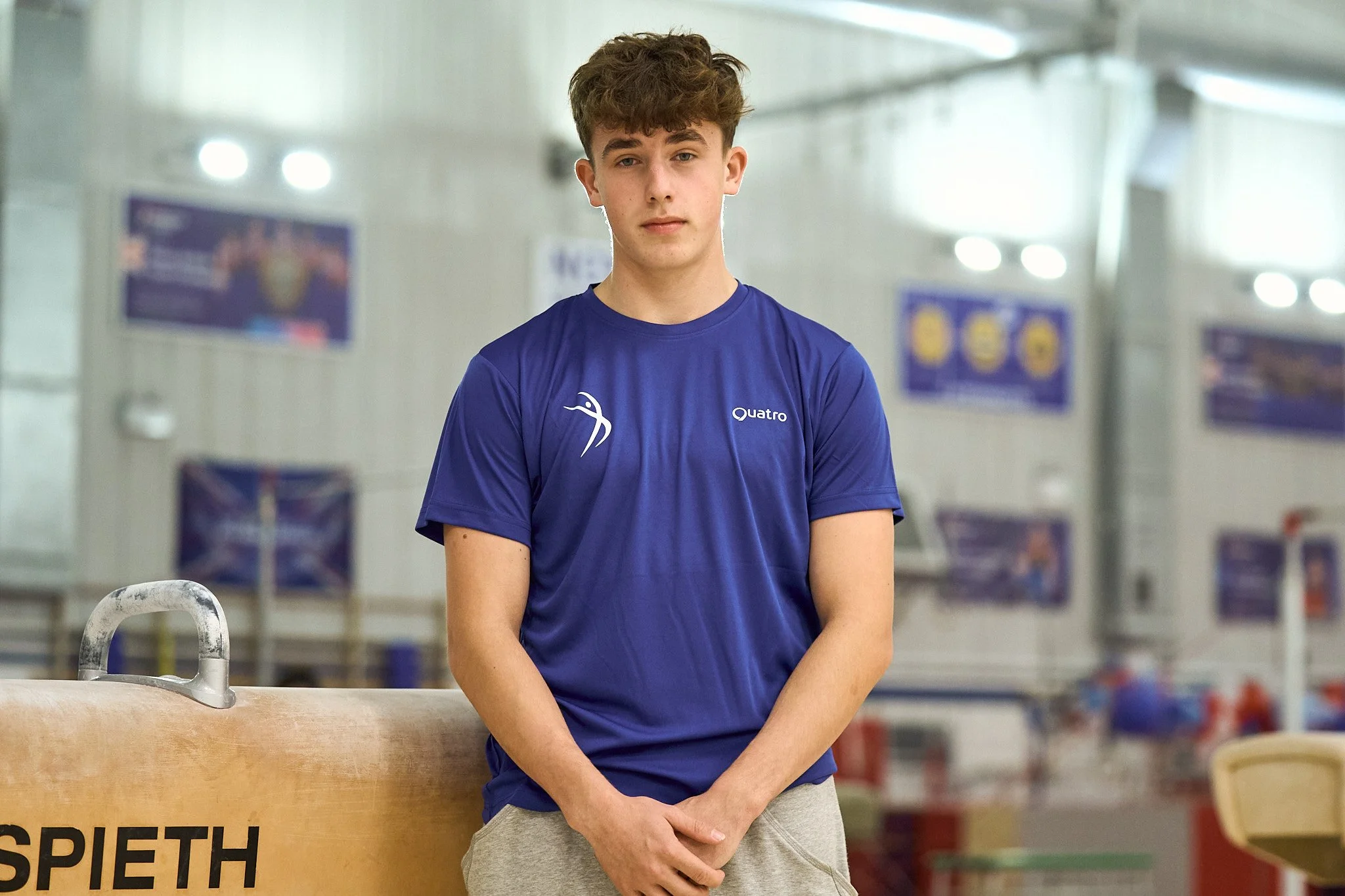 Silhouette of a man with styled hair against a purple gradient background.