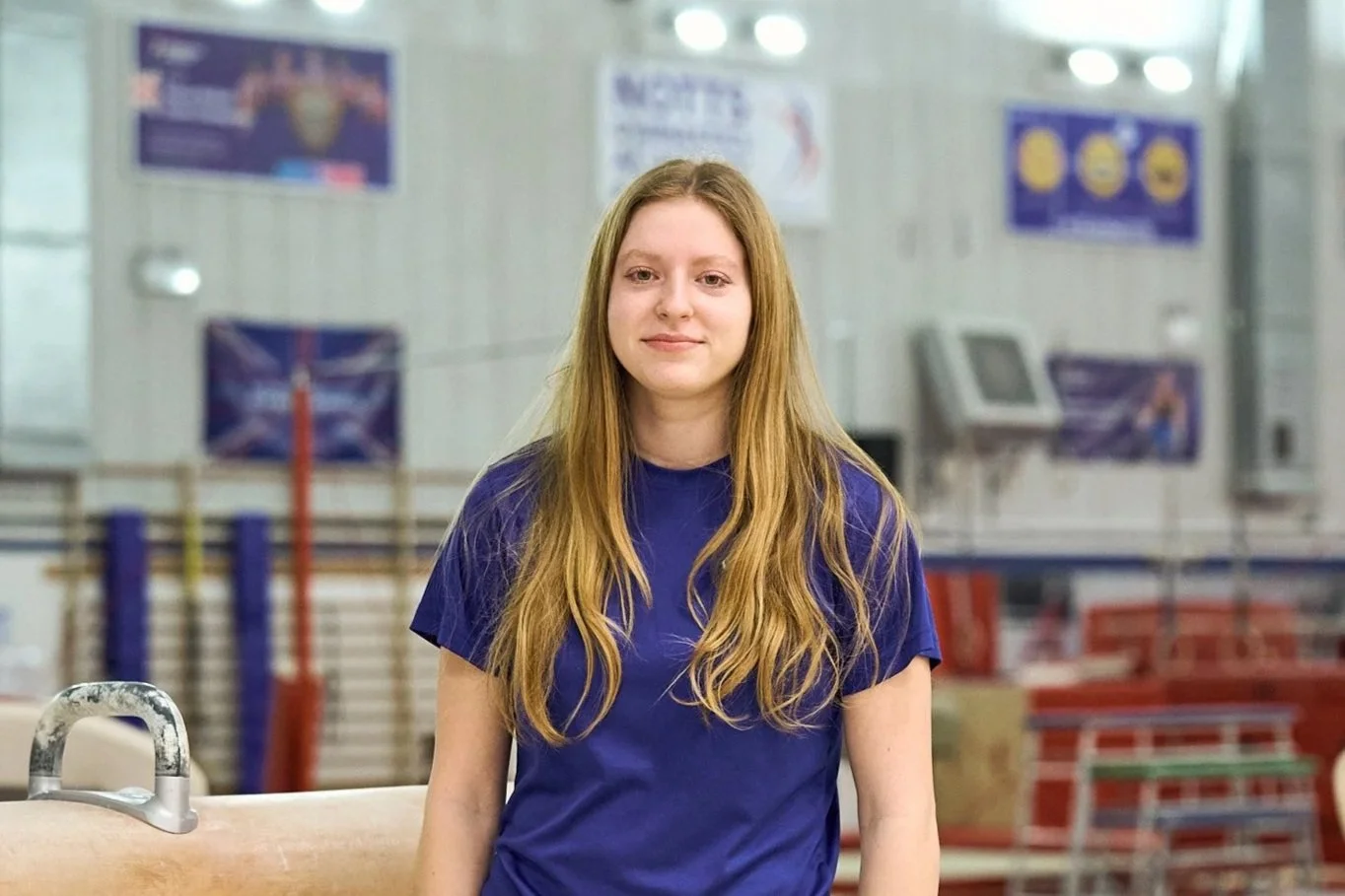 Silhouette of a man with short hair against a purple and blue gradient background, turned slightly to the side with eyes closed.