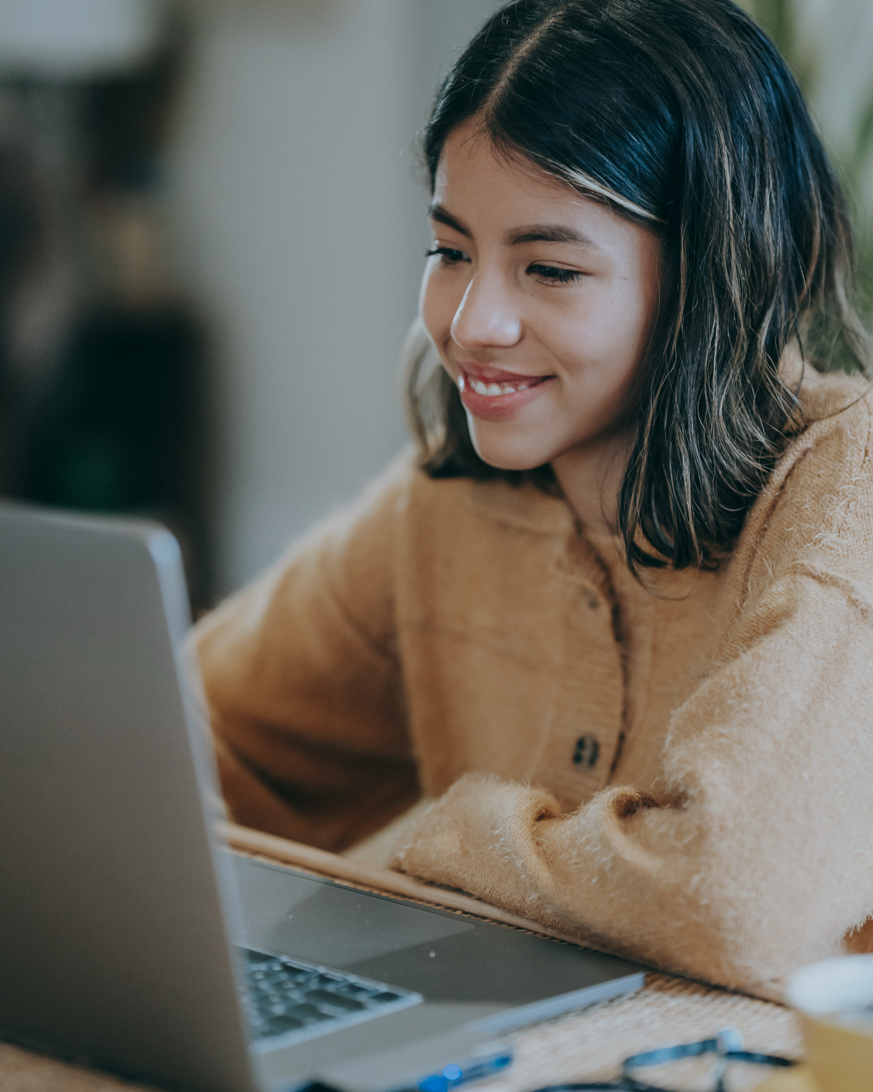 Student studying on a laptop at a table