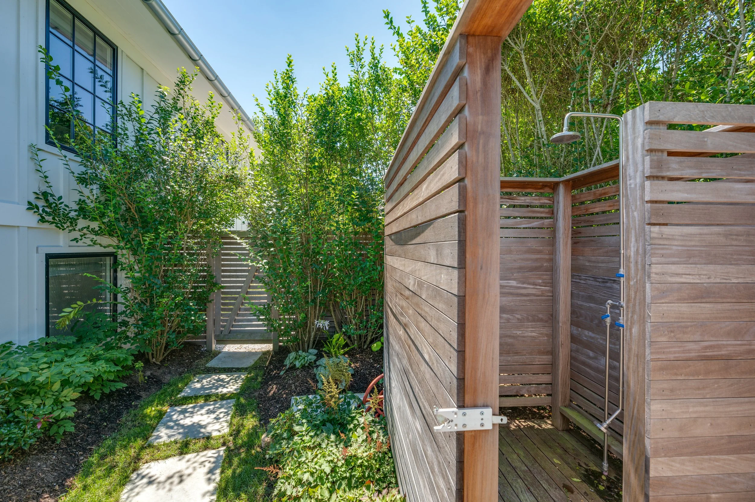The outdoor shower and changing area is perfect for a post-beach rinse and pool parties.
