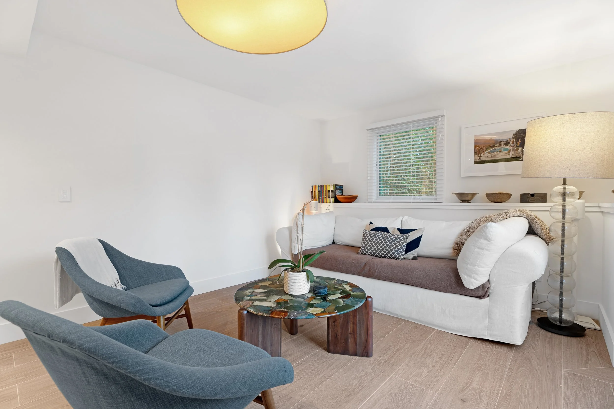 The downstairs living room connects a king-sized bedroom suite with the outdoor patios and garden.