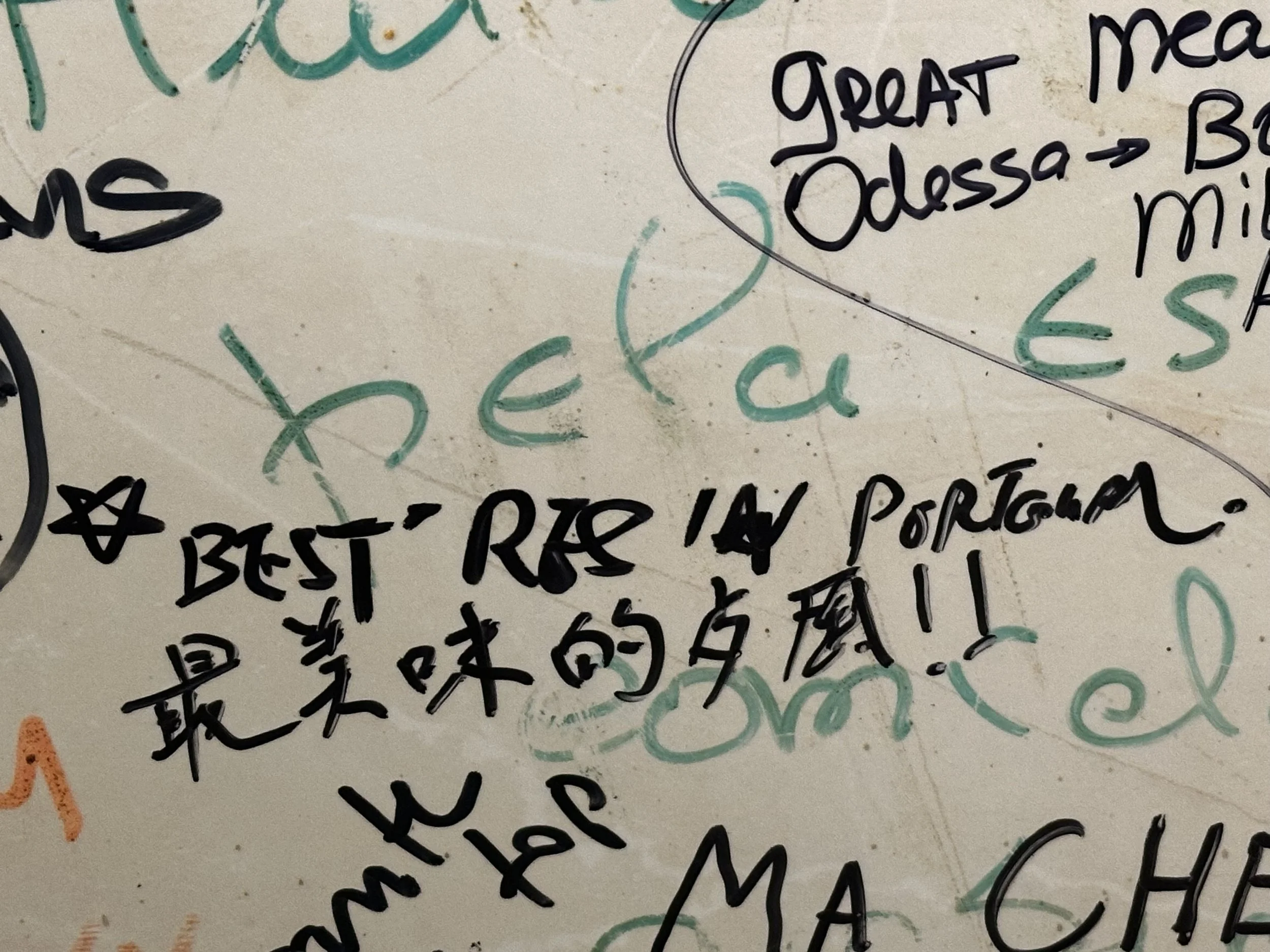 Whiteboard with handwritten notes in English and Chinese, mentioning 'best rice in Portugal' and various locations like 'Mexico', 'Odessa'.