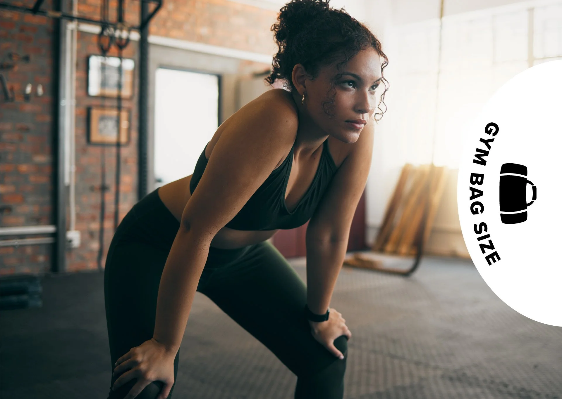 A woman in workout clothes leaning forward, taking a break in a gym with brick walls and exercise equipment in the background, and a text overlay that says 'Gym Bag Size' with a bag icon.