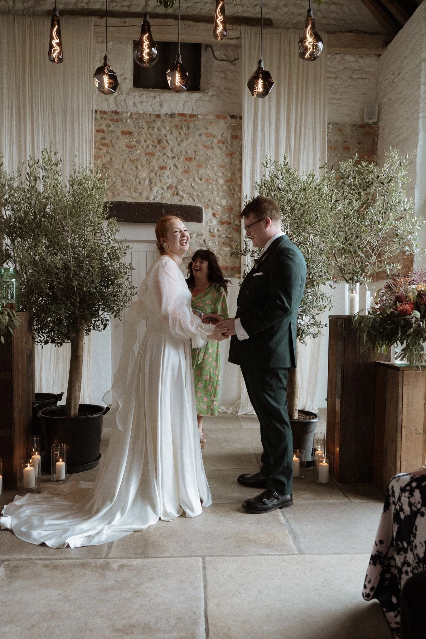 bride and groom laughing with wedding celebrant, Norfolk