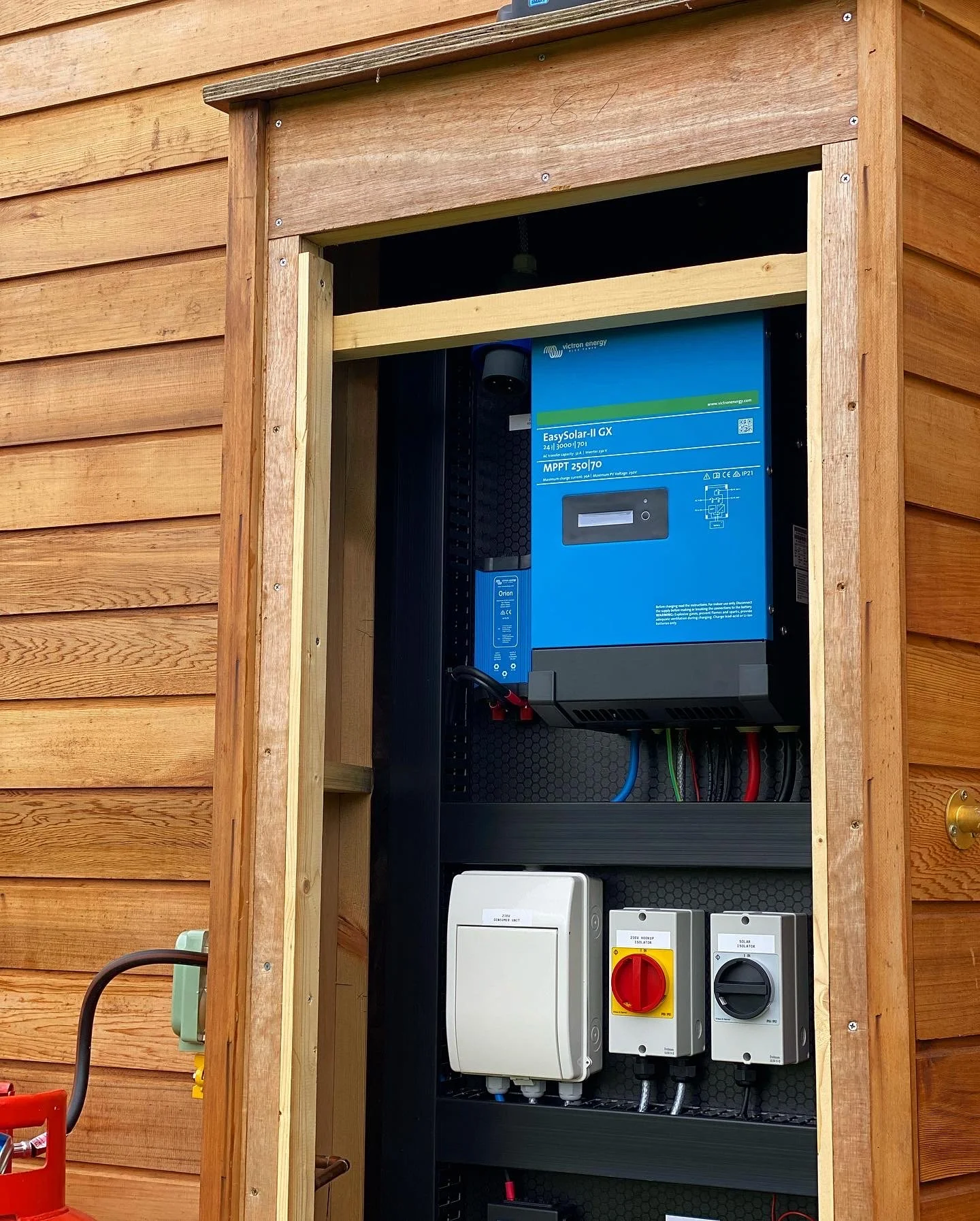 Electrical inverter system and circuit breakers installed in a wooden outdoor panel, used for solar power system.