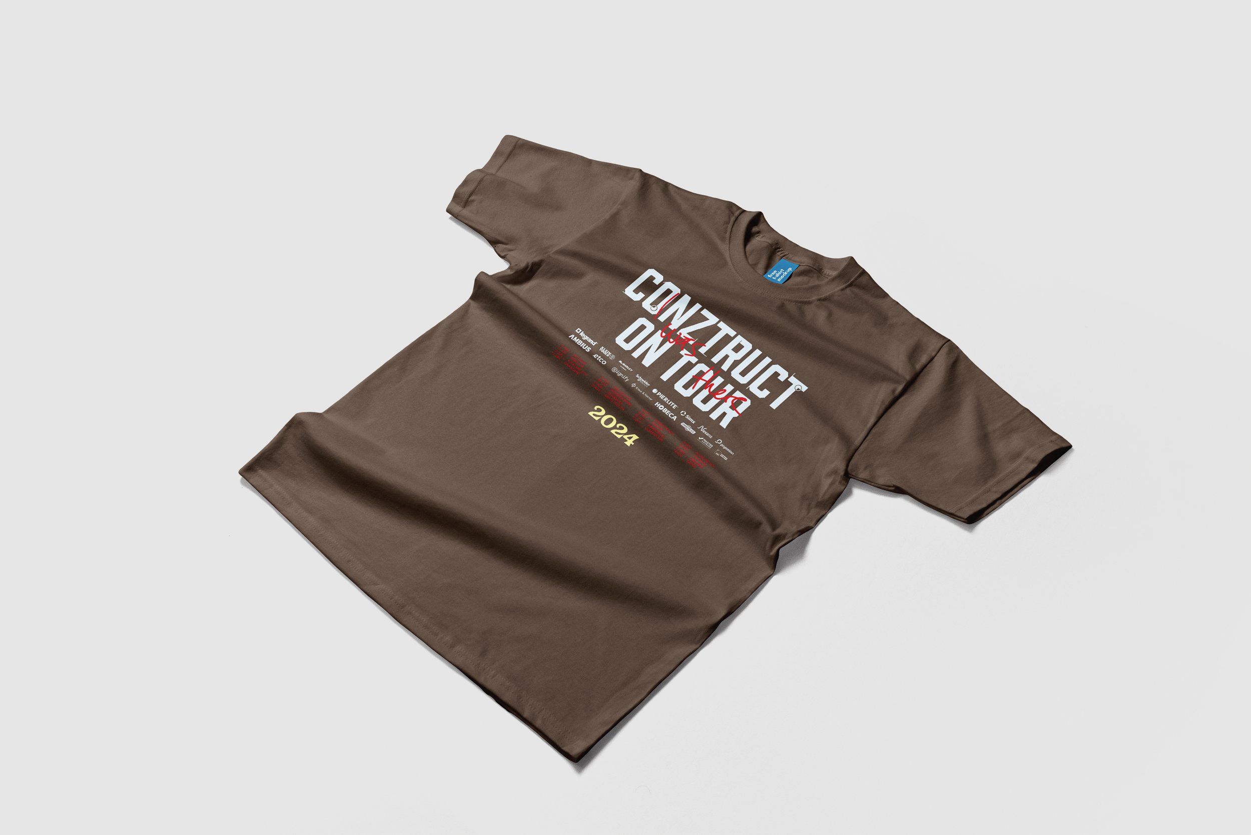 Brown T-shirt with text reading 'Construct and Destroy' and '2024' printed on the front, laying on a white surface.