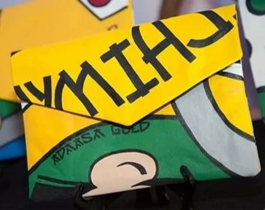 Colorful packaging with yellow, green, gray, and purple sections, featuring partially visible text and symbols.