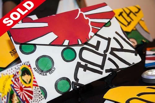 Collection of various poker chips and playing cards, with one card marked with a red 'SOLD' sign.