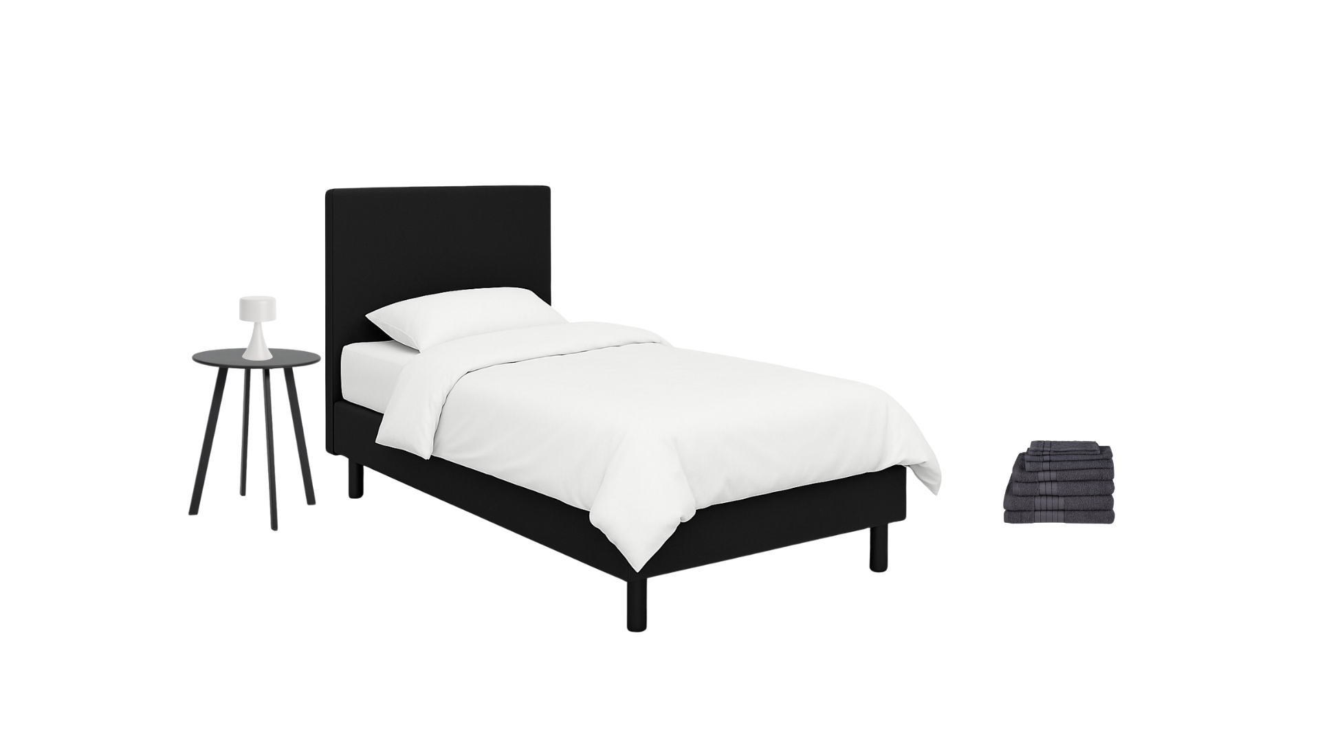 A neatly made bed with white bedding and pillows, a black padded headboard, a black side table with a modern white lamp, and a pile of folded dark gray towels on the floor.