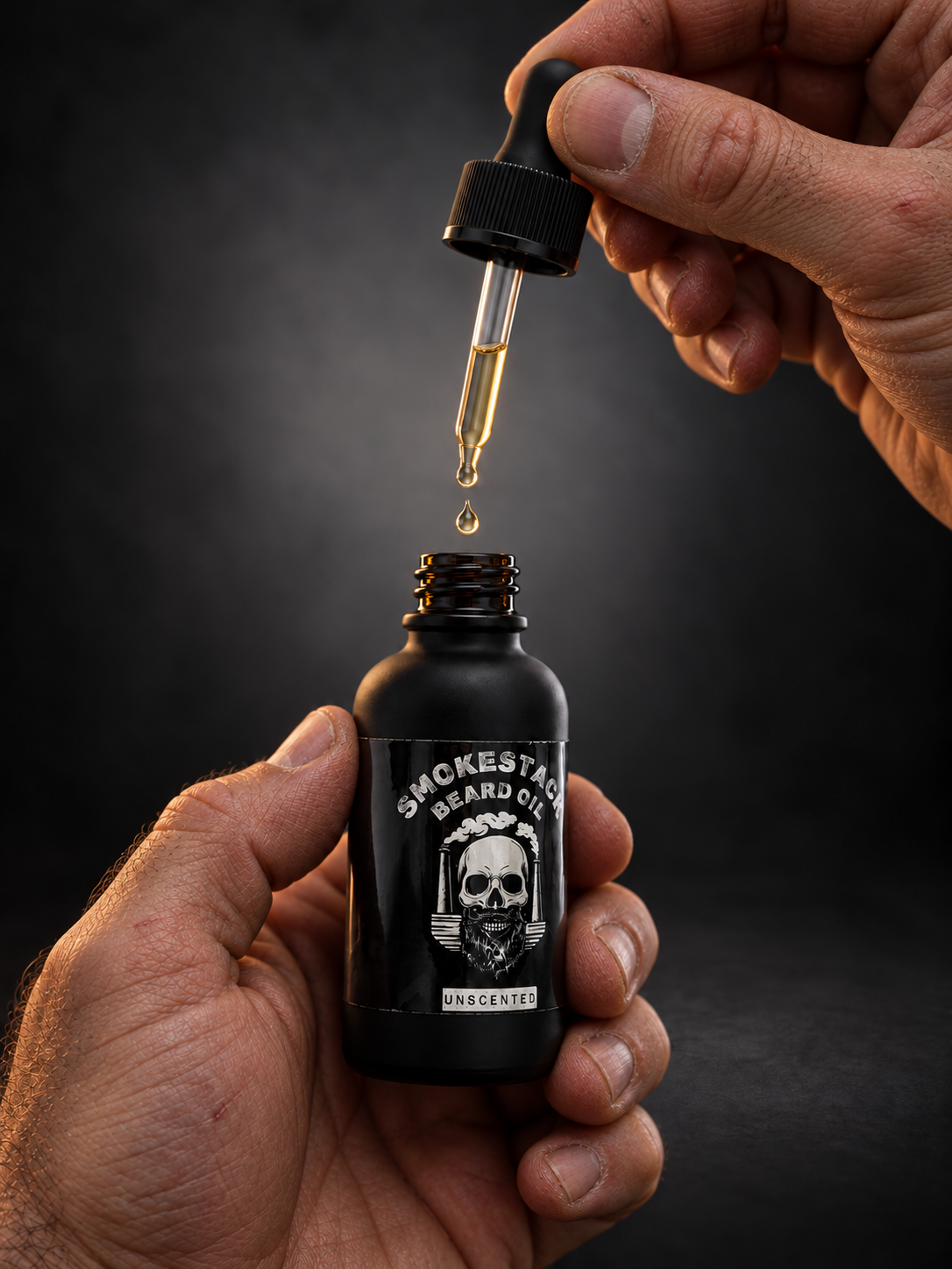 Rugged hands with beard oil bottle.png