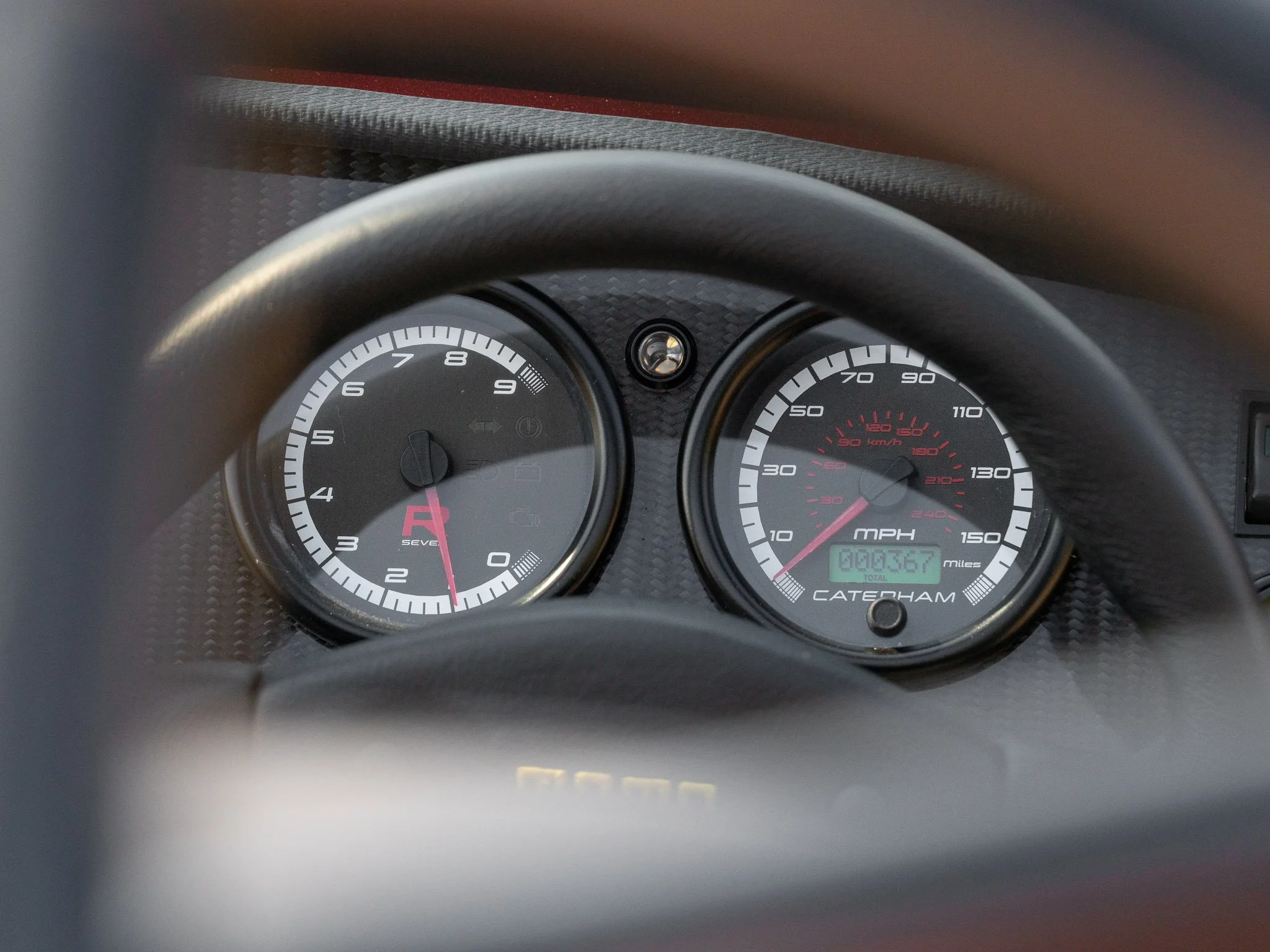 Car dashboard showing tachometer with RPMs and speedometer with miles per hour, with the odometer reading 3,367 miles.