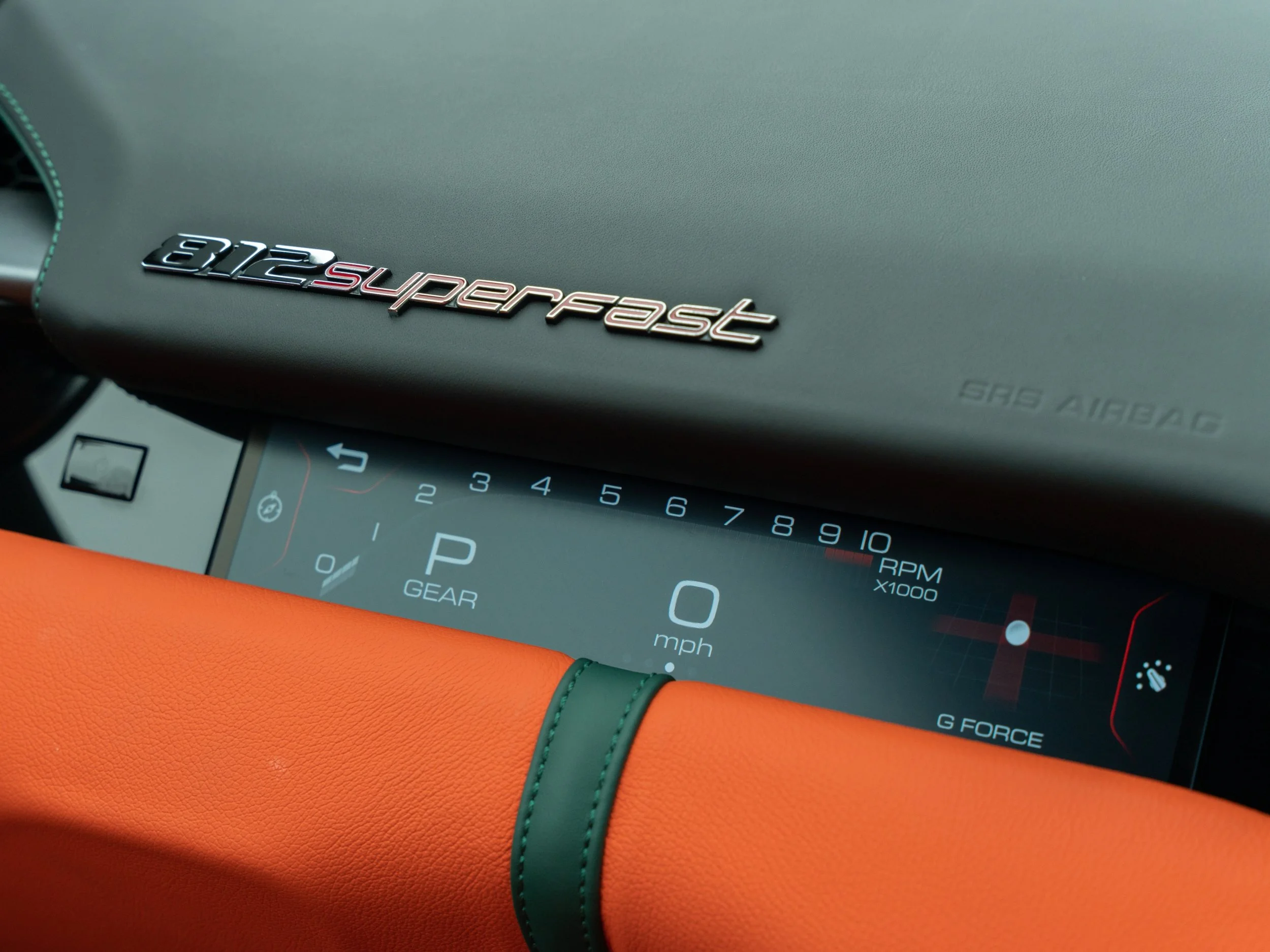 Close-up of the dashboard of a McLaren 720S superfast sports car, showing digital speedometer at zero mph, gear in park, and tachometer up to 10,000 RPM.