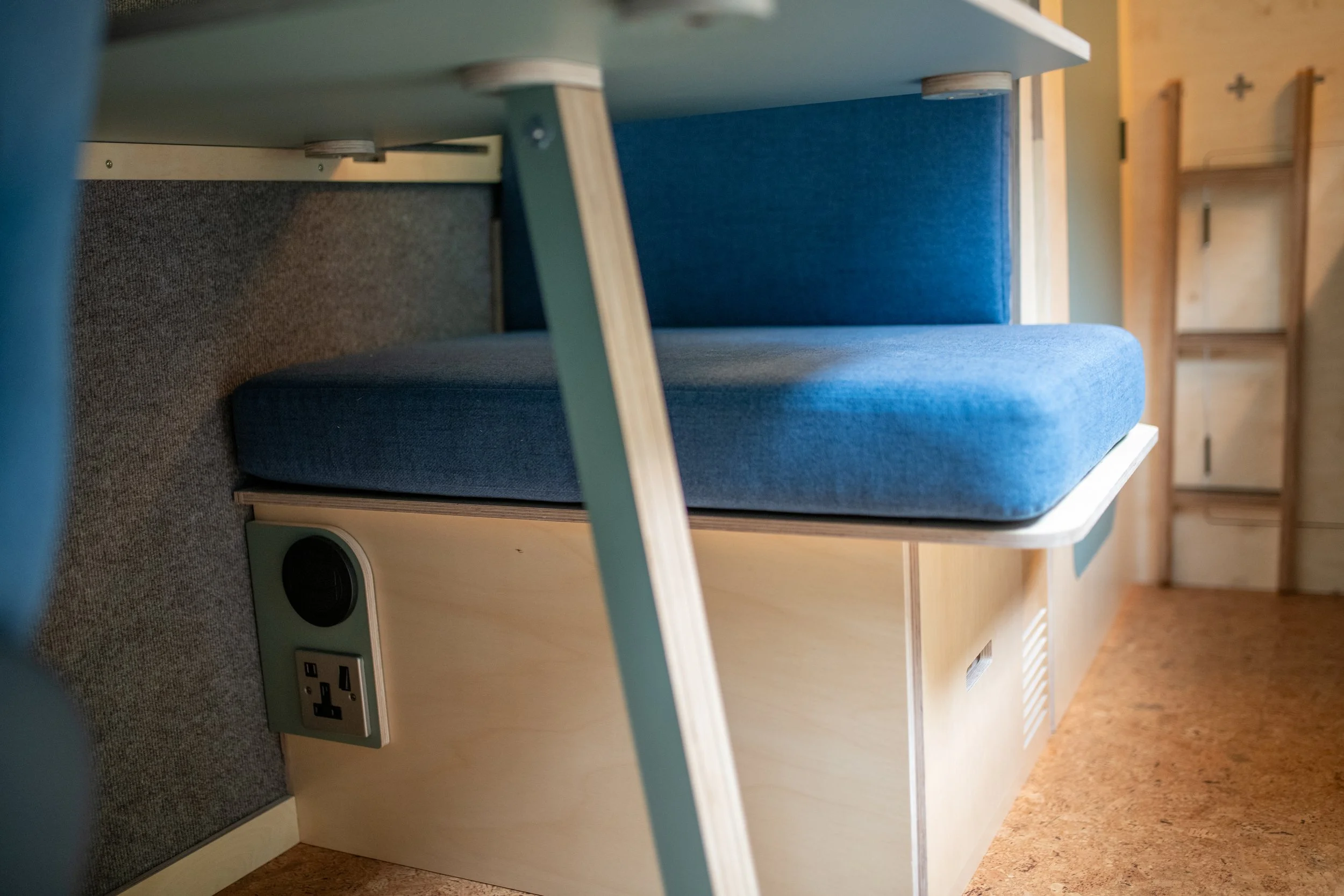UK household socket and 12-volt outlet neatly built into the base of the Fern campervan's seating, powered by a 3000W inverter for using everyday appliances off-grid.