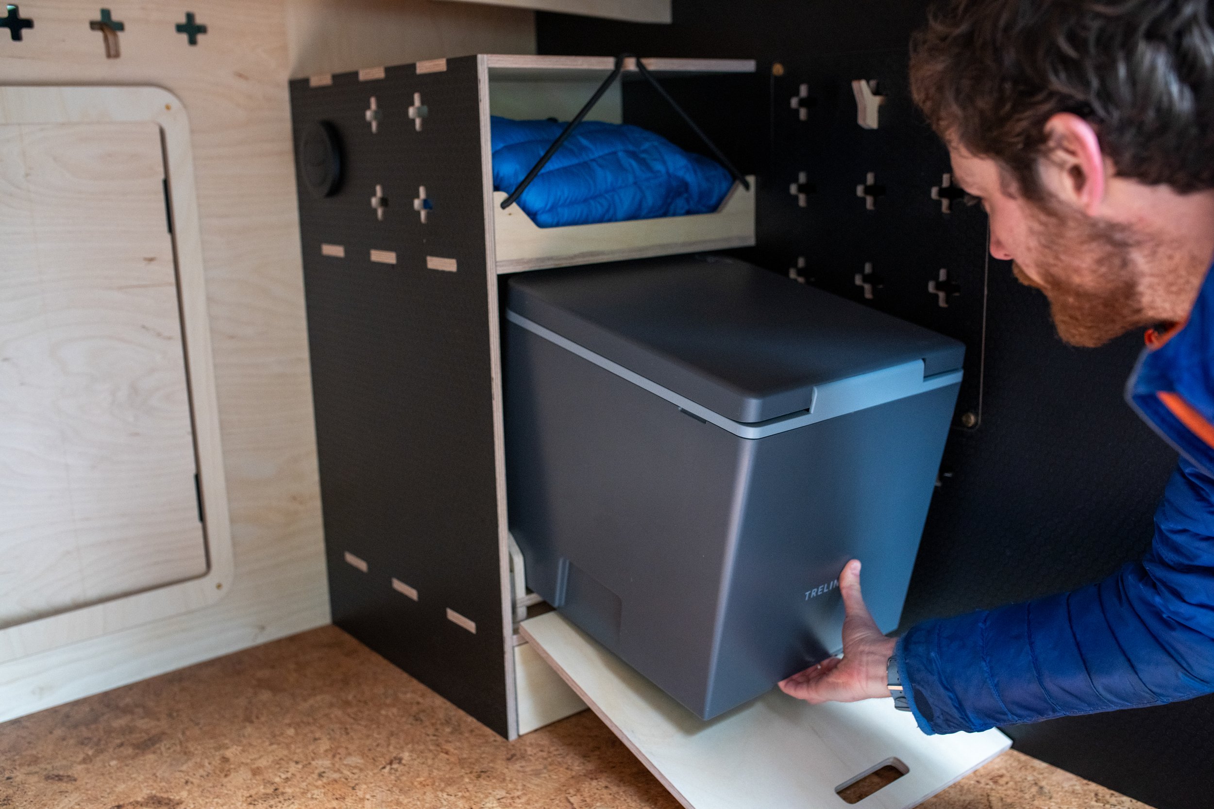 Slide-out Trelino composting toilet, accessed from the campervan's garage, giving easy emptying while keeping the onboard loo fully integrated for off-grid use.
