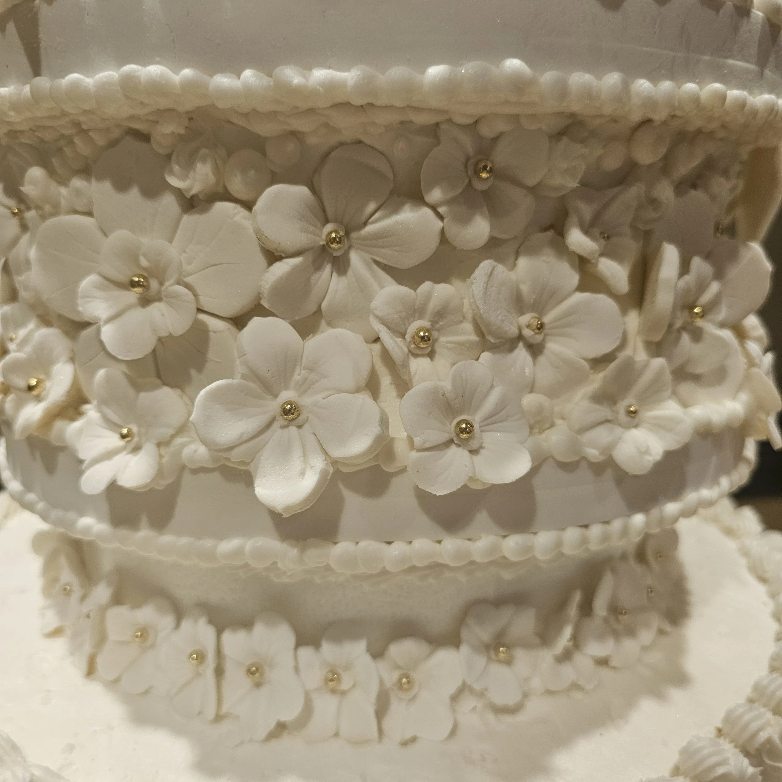Decorated birthday cake with a black and white photo of Marilyn Monroe printed on top, surrounded by white frosting, black accents, and red frosting roses, with red cursive writing that says "Happy 28th Birthday Louick."