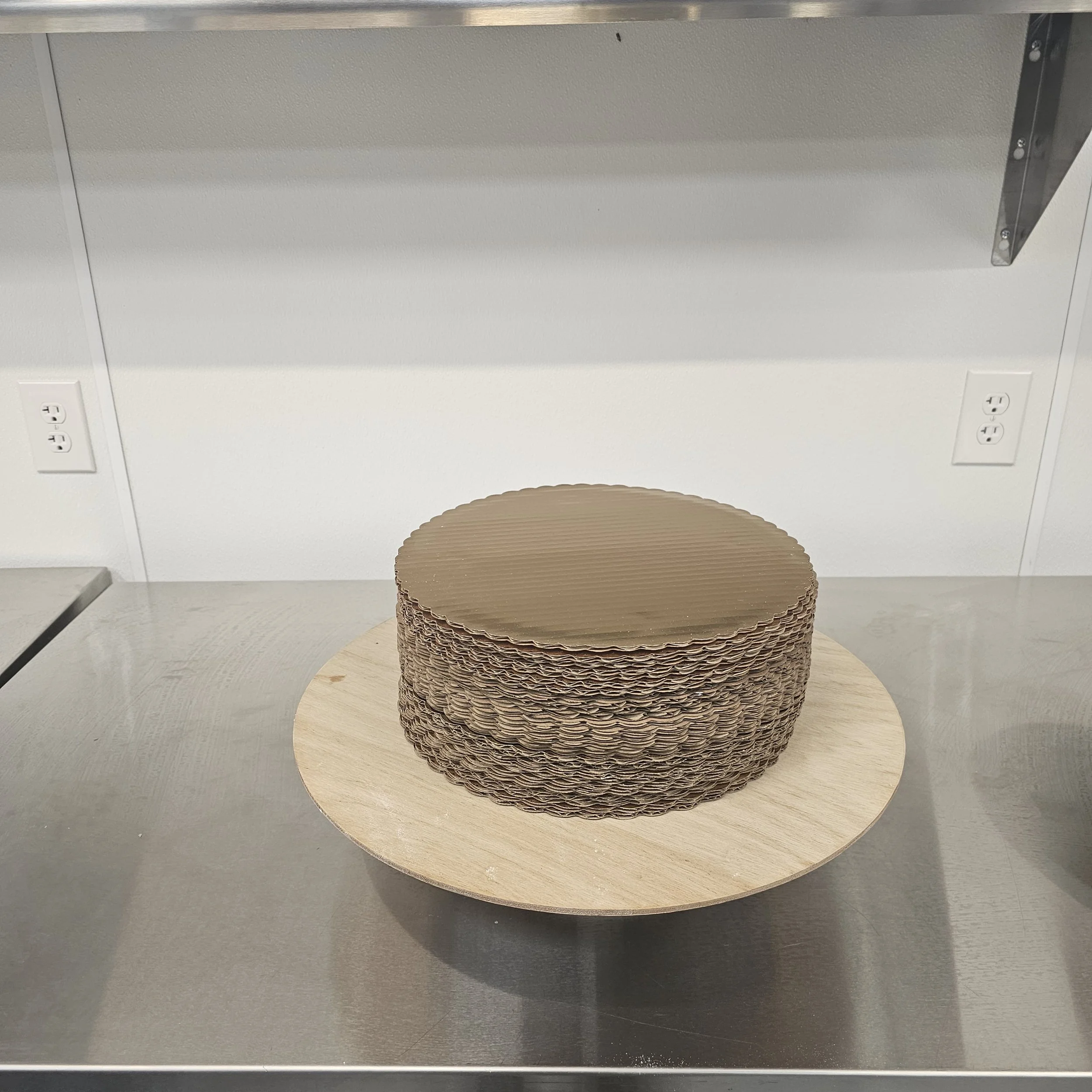 Three-tier Marvel Avengers themed birthday cake with superhero images, colorful icing, and red, green, black, and red decorative balls on a silver cake board. The message in red icing reads "Happy 4th Birthday Fat Dadddy."