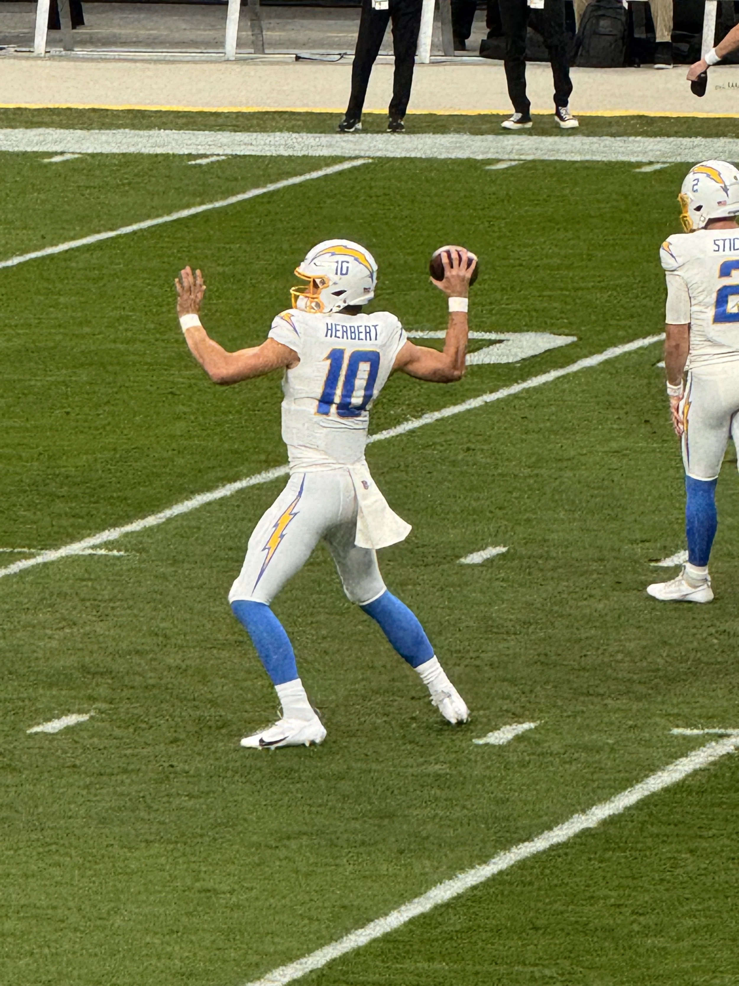 Justin Herbert in a white and blue uniform with the number 10 during a game against the Las Vegas Raiders