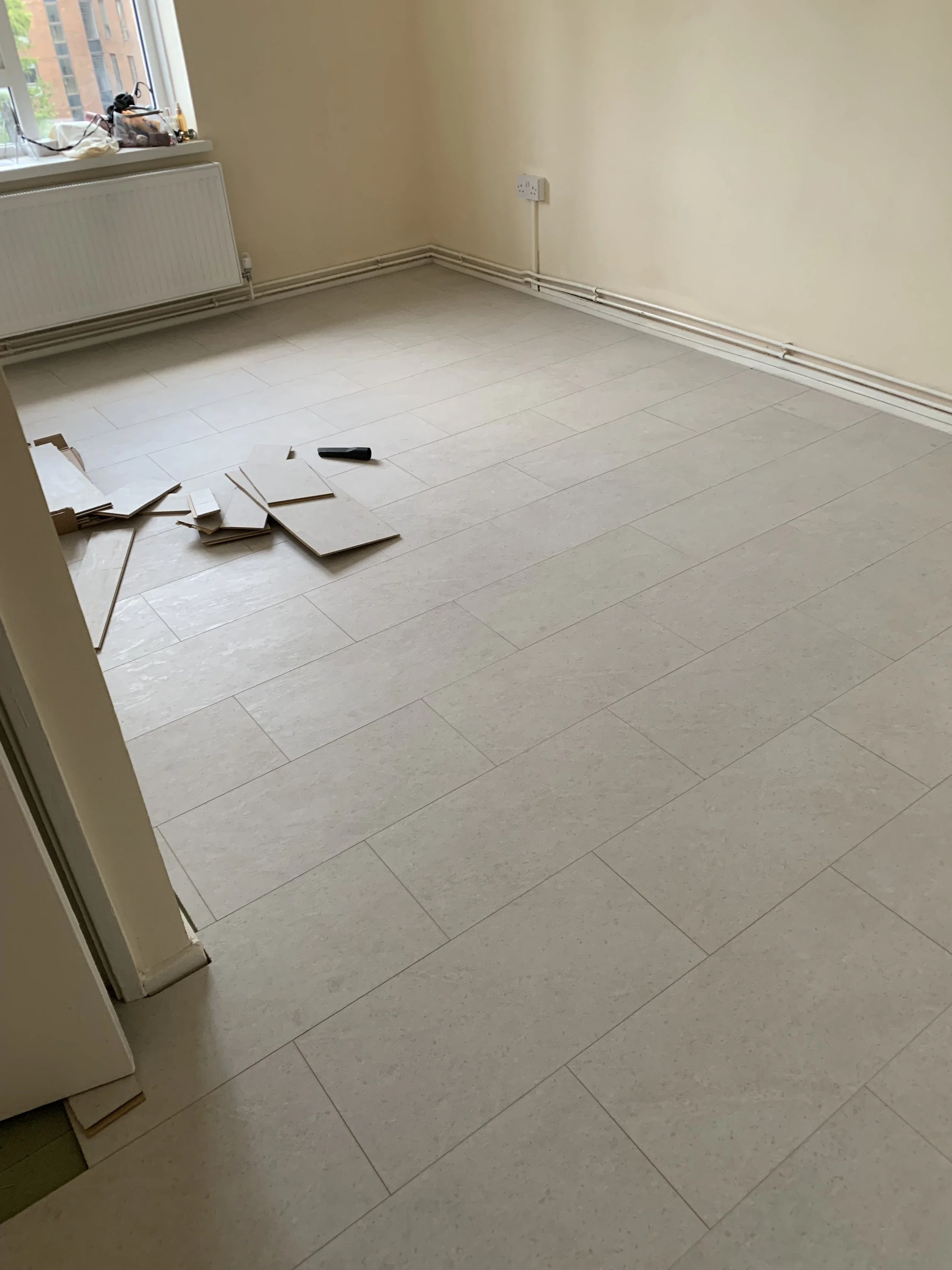 Newly laid Laminate wood flooring in a marble tile effect