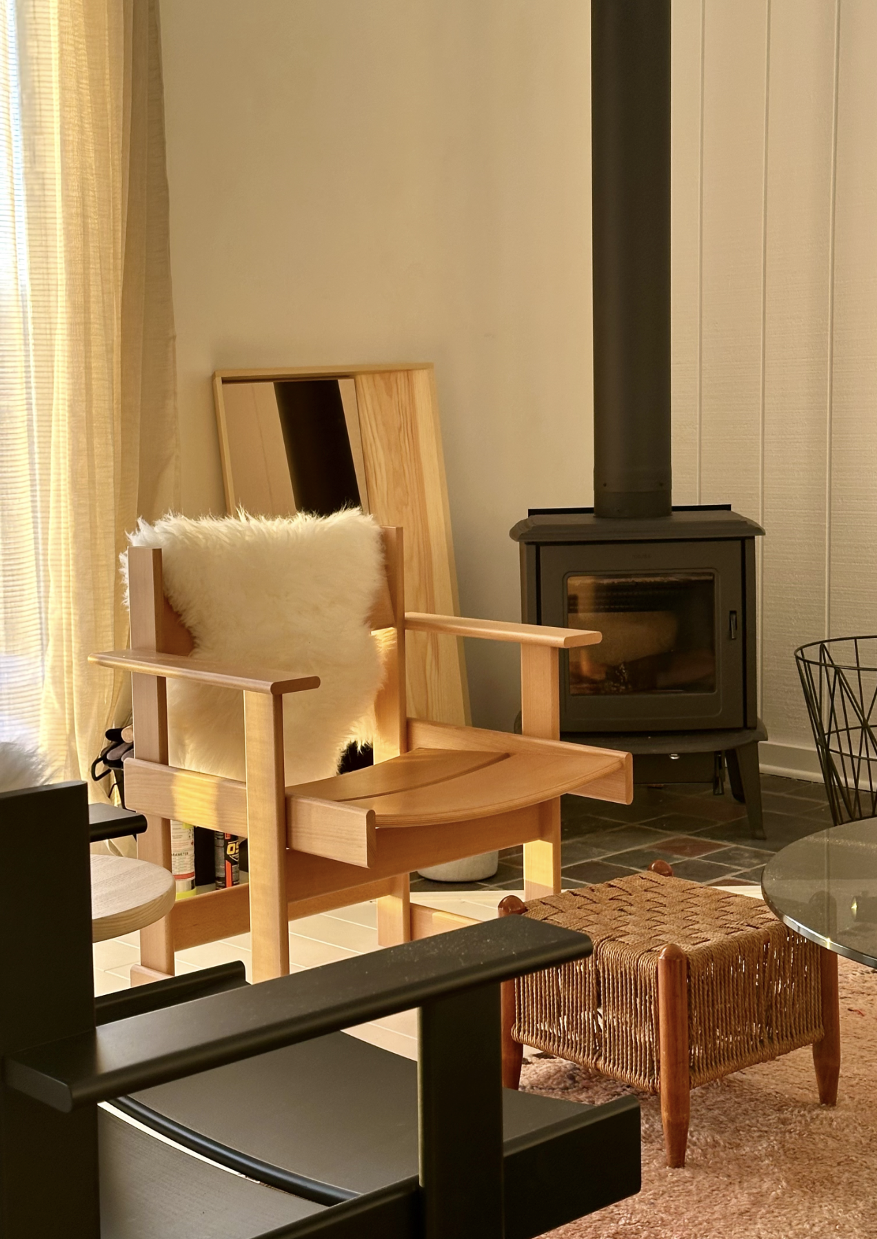 Cozy Morso wood stove with Hem Bullnose chair and Vaarnii mirror