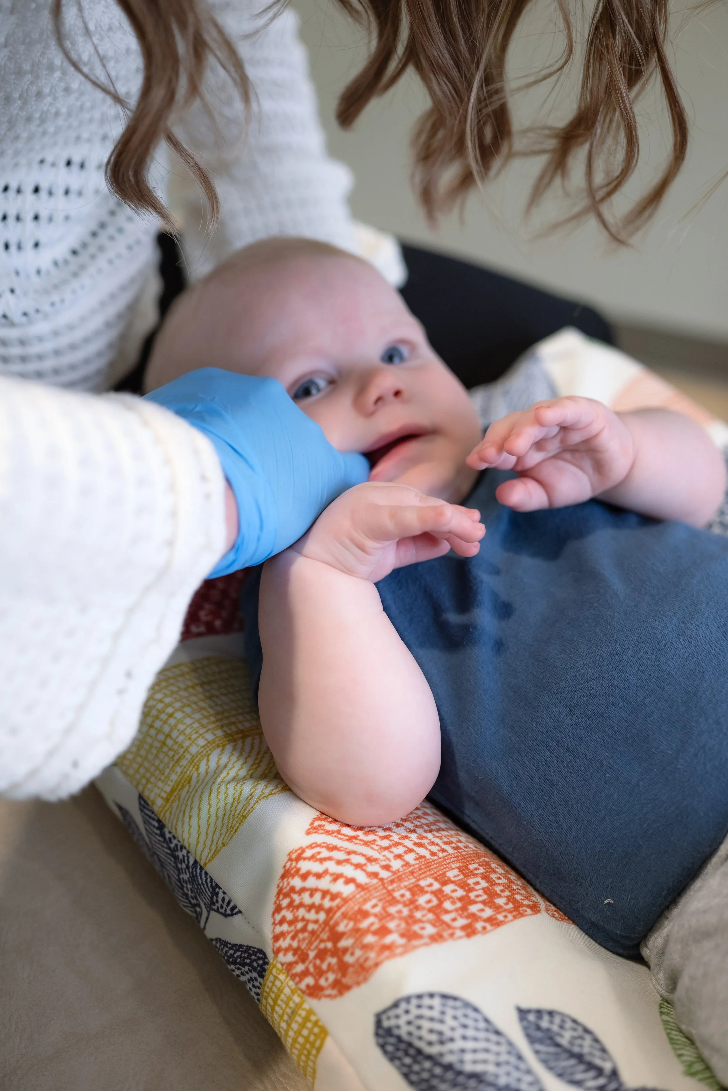 Baby exam at Nurture 360 focusing on oral function and body tension release, part of Windsor-based infant chiropractic care.