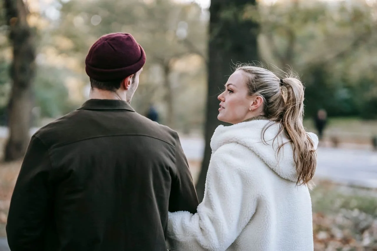 young-romantic-couple-walking-and-communicating-in-autumn-park