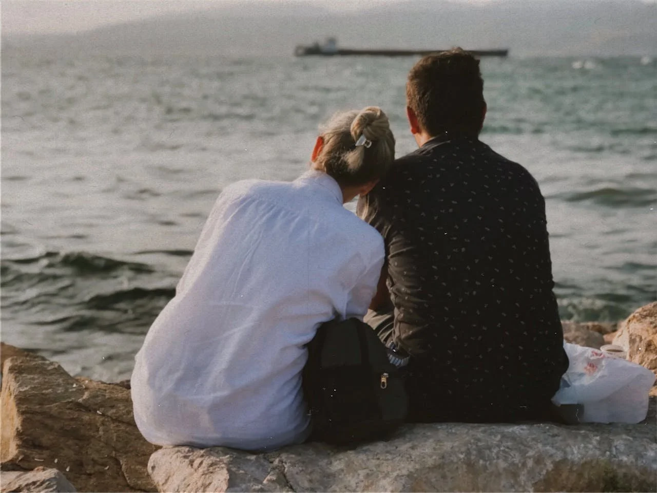 man-and-woman-relaxing-by-sea