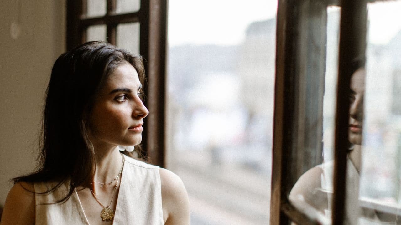 pensive-woman-looking-out-window