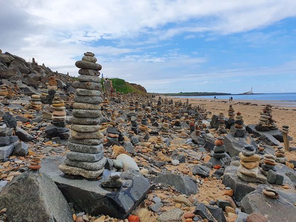 Piles of stacked rocks on a beach