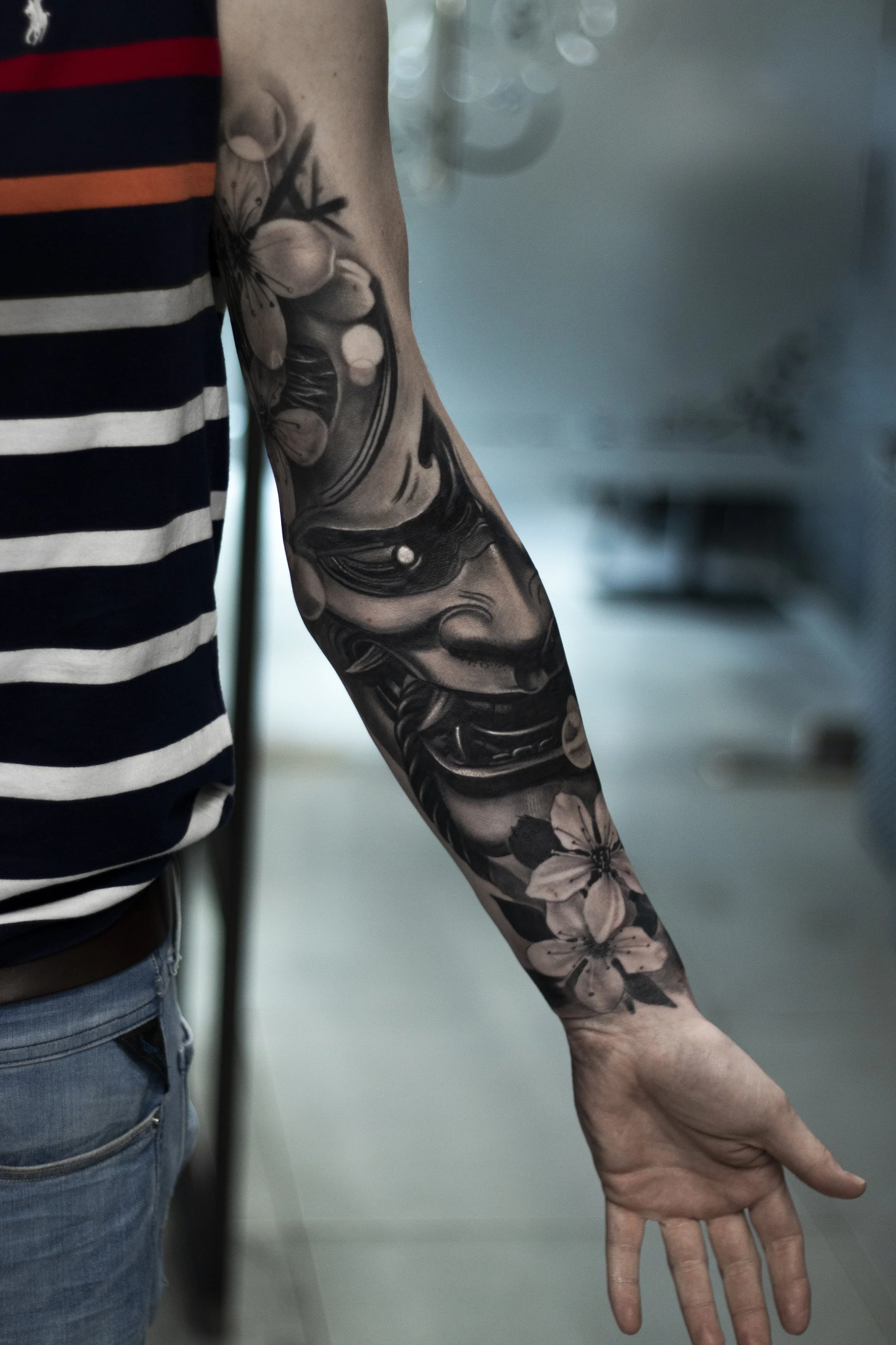 Black and grey Japanese realism tattoo on a forearm by artist Steve Upton