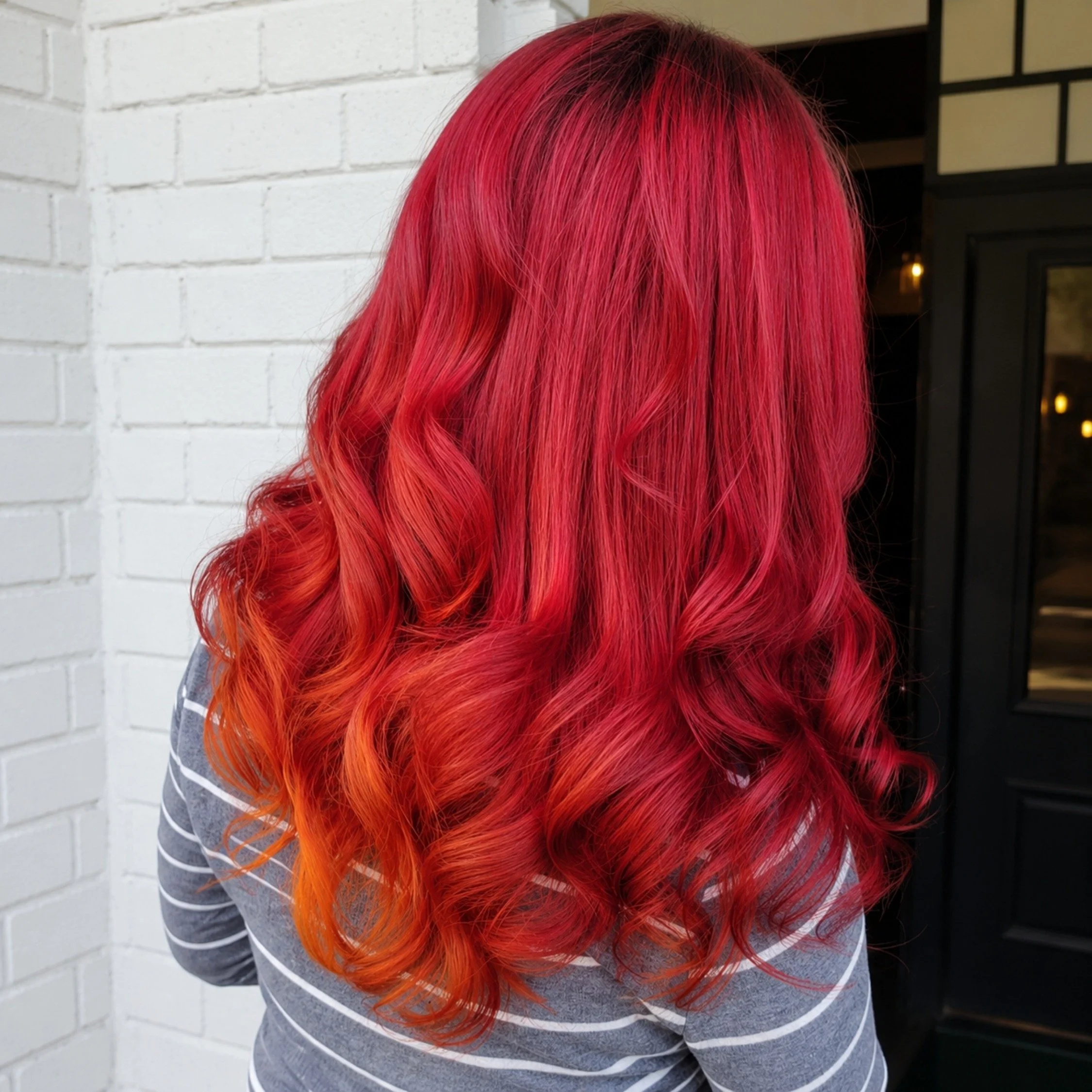 Back view of a person with long, Vibrant purple shoulder-length hair with smooth texture and curled ends at Studio 285 salon