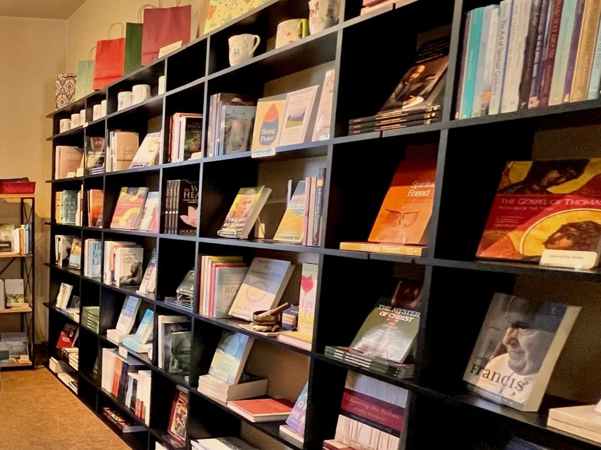 Bookshelves filled with books and magazines in a bookstore or library.