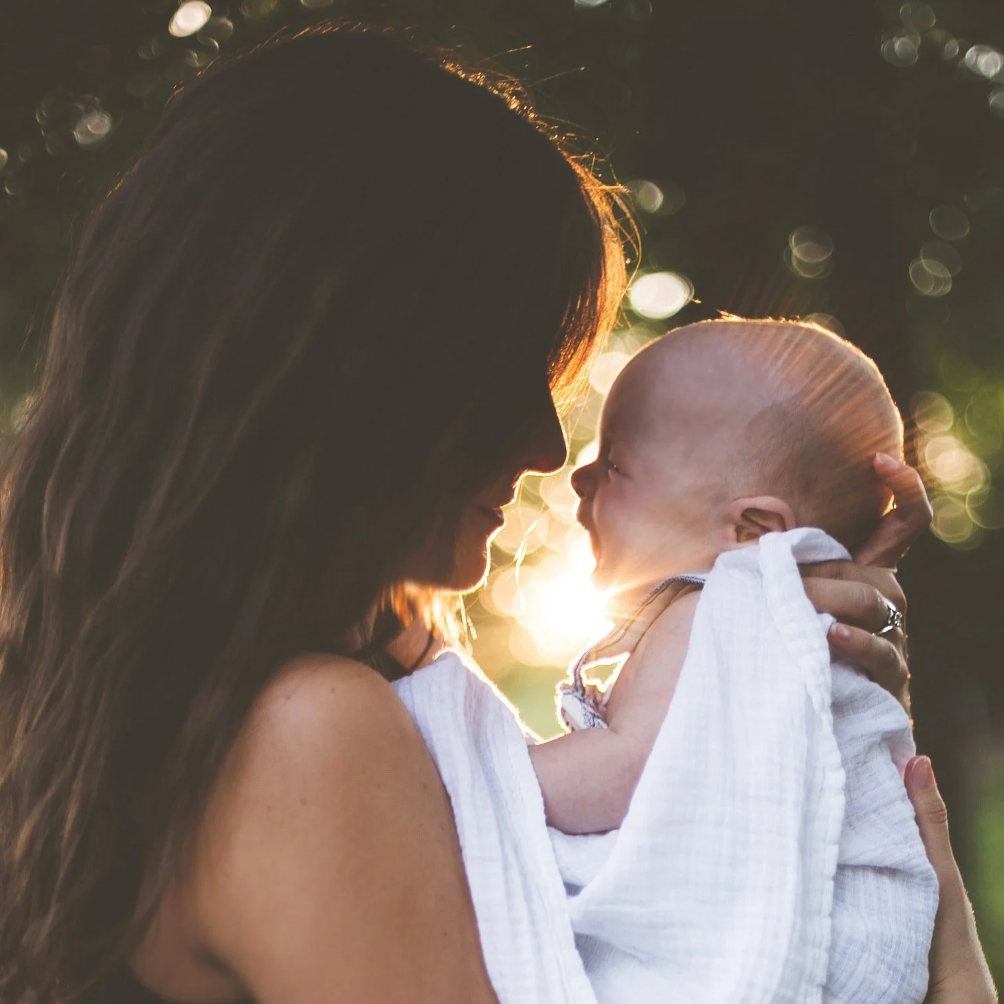 Mom holding baby and smiling after conceiving naturally