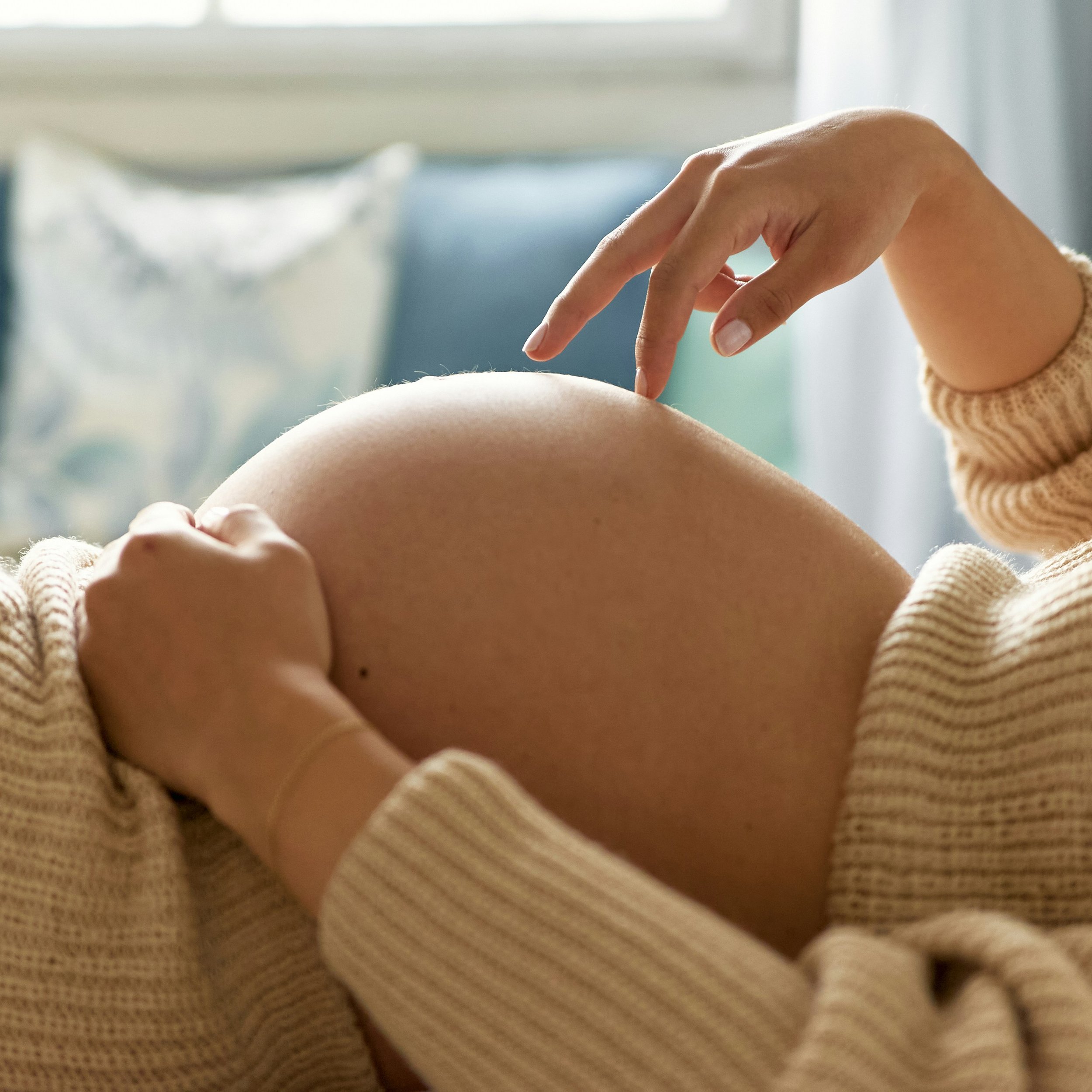 Pregnant woman receiving safe prenatal acupuncture treatment