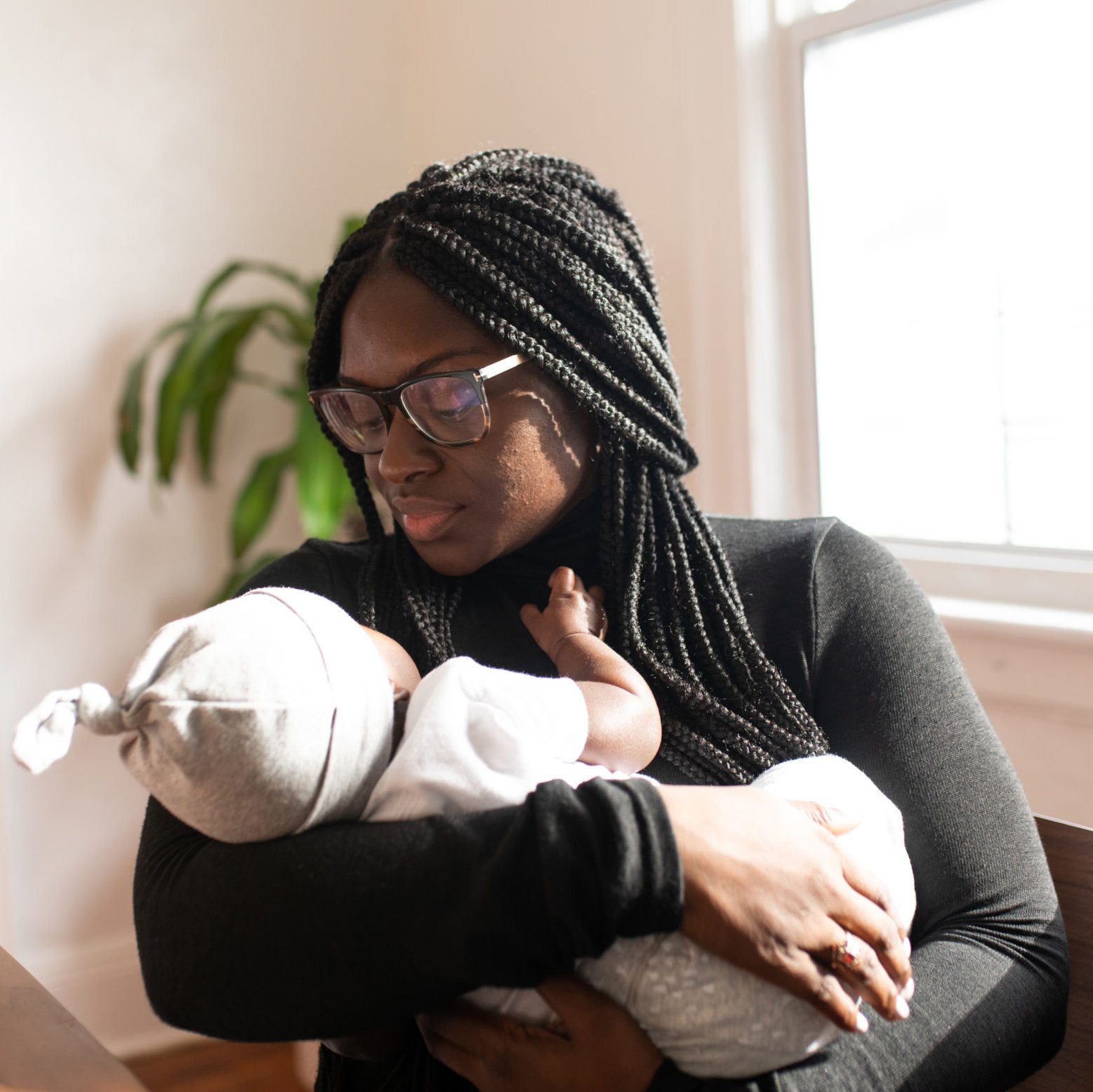 Woman holding baby after delivering in Encinitas