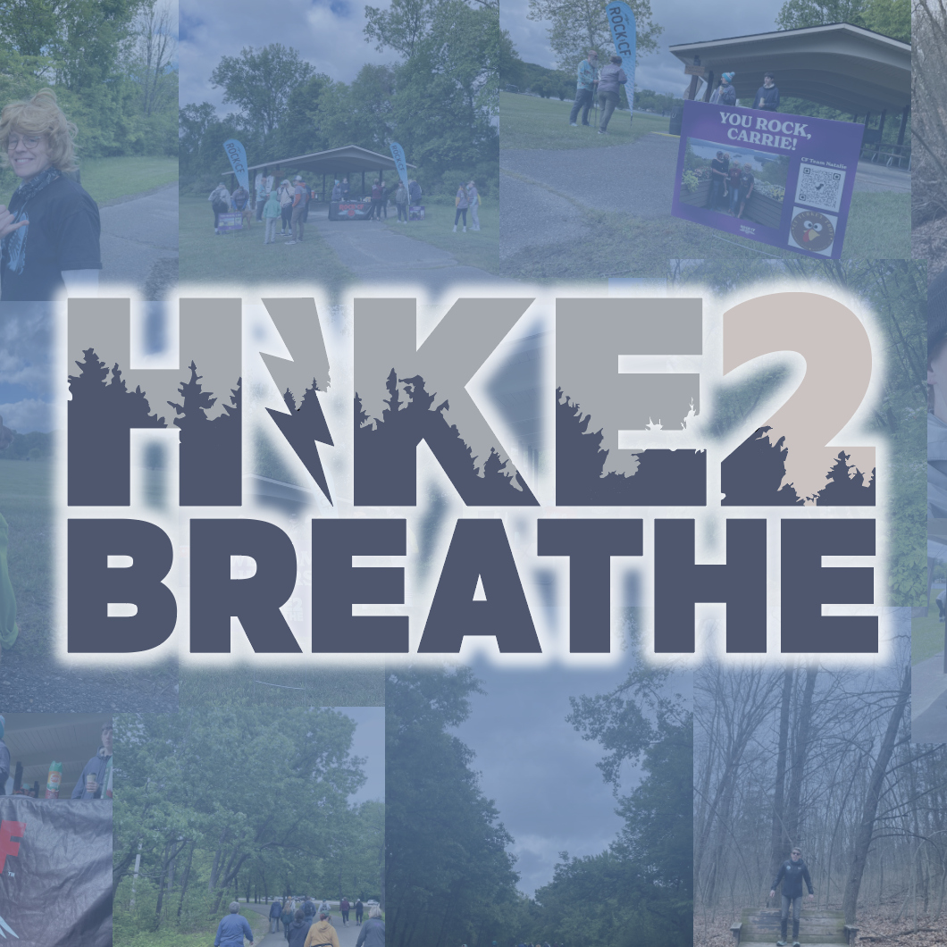 Woman hiking on a forest trail with a backpack surrounded by tall trees and lush greenery