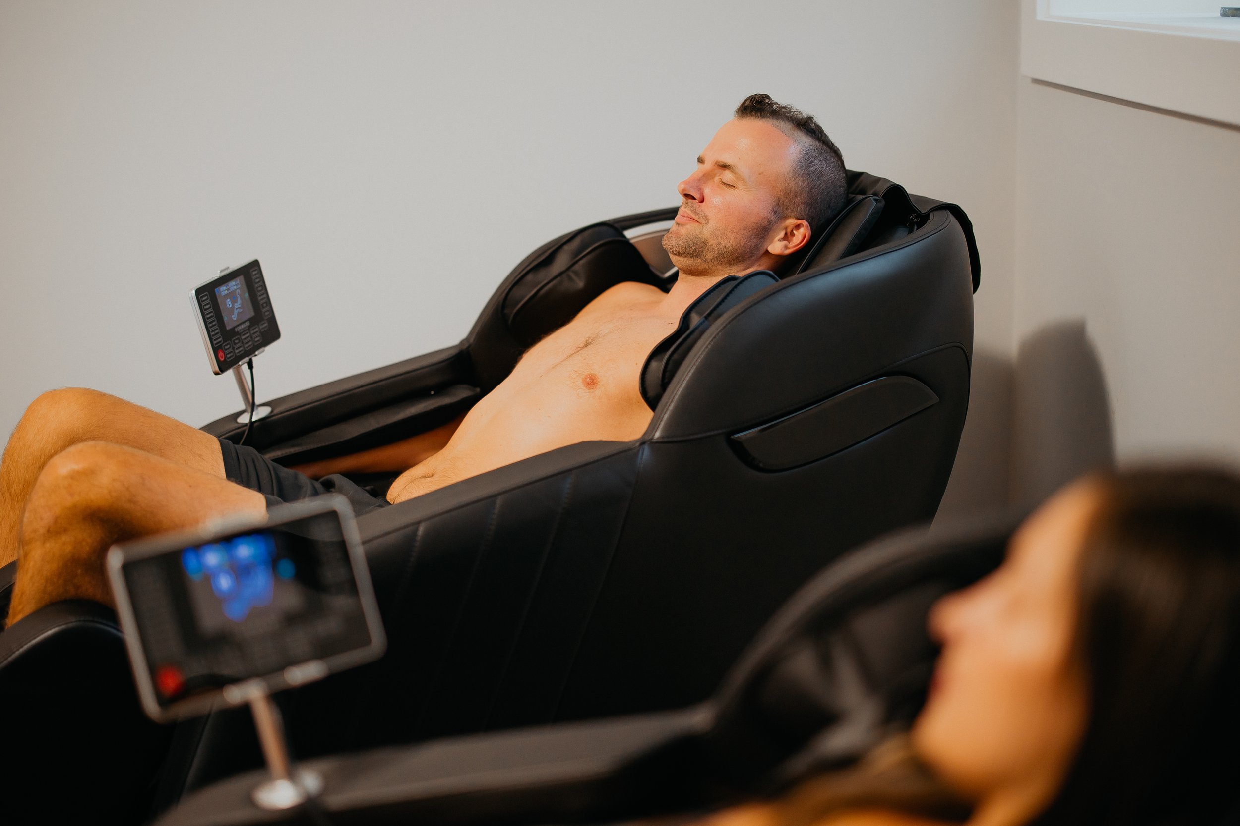 The Thera Retreat, a man sitting in a massage chair