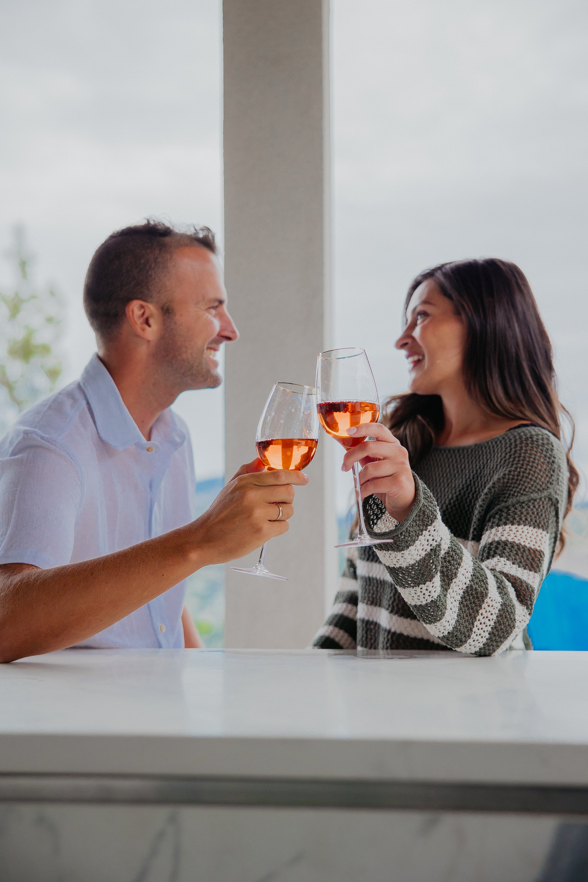 couple happily talking with wine glasses in hand