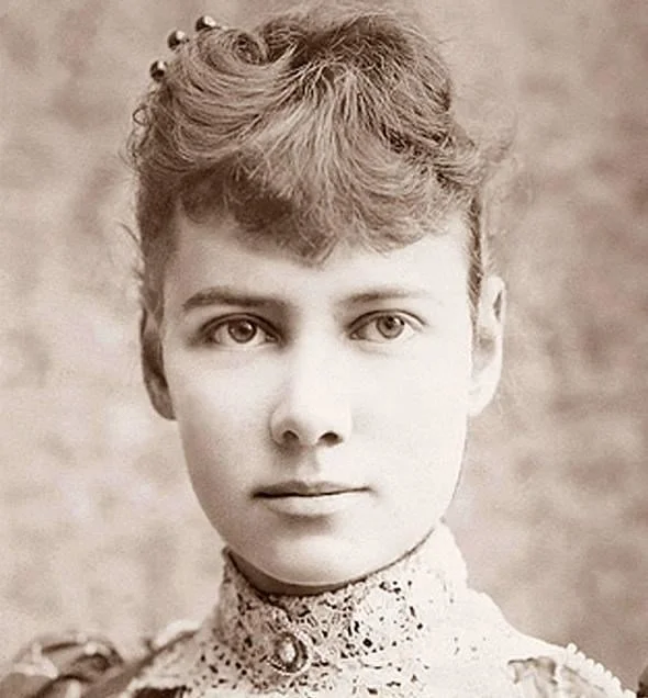 A vintage black and white portrait of a young woman with short, wavy hair, wearing a high-collared lace blouse.