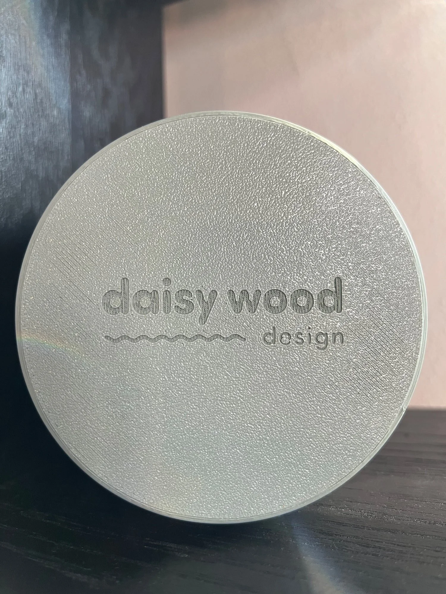 bottom of sage planter with daisy wood design logo engraved