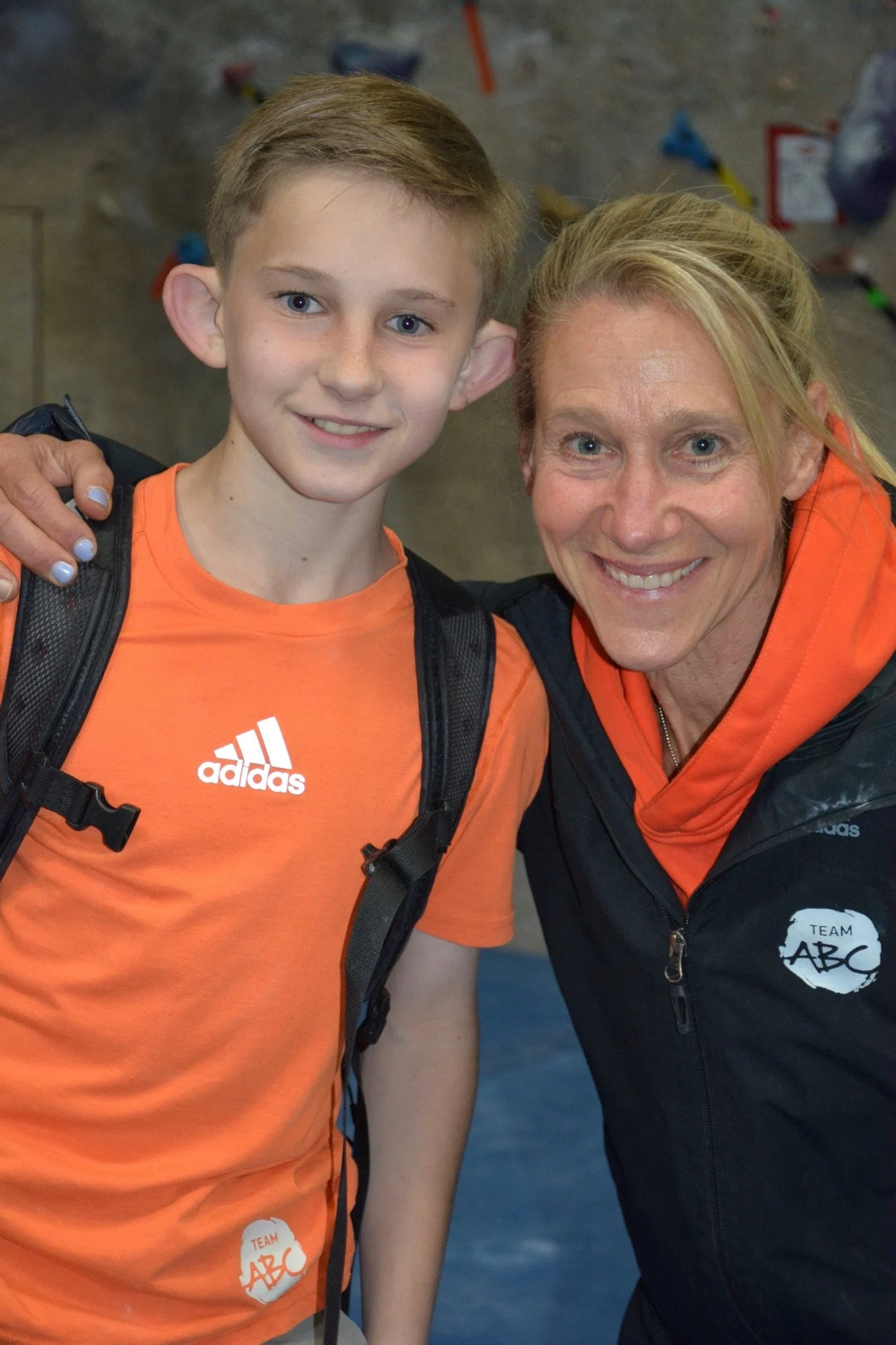 Robyn Erbesfield-Raboutou smiling with a young climber at a competition