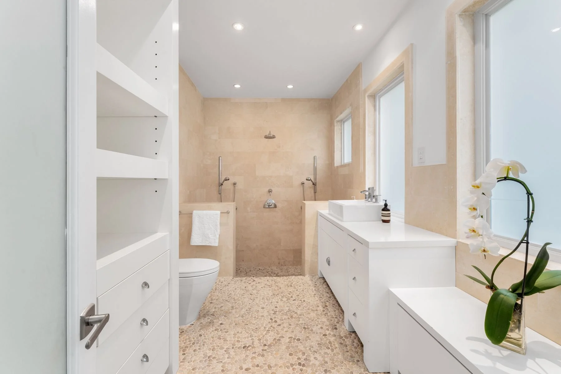 Cabana Bath with custom cabinetry for beach towels and laundry; direct access to pool and patio