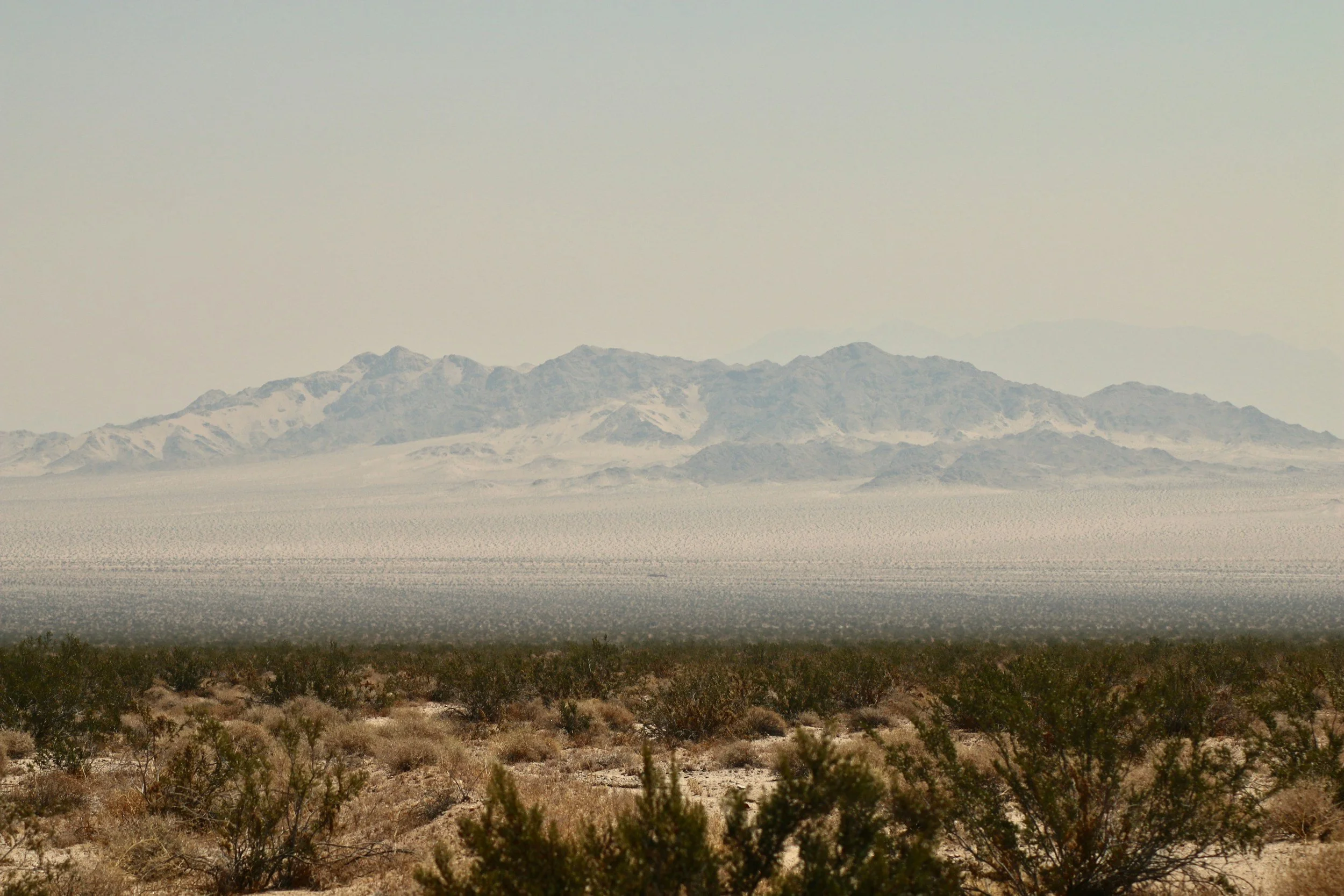 Wide expansive image of the desert floor moving towards the mountains representing the changes one will encounter as they commit themselves to trauma therapy in San Diego