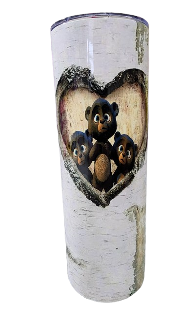 A white cylindrical object with a heart-shaped cutout revealing three plush teddy bears inside.