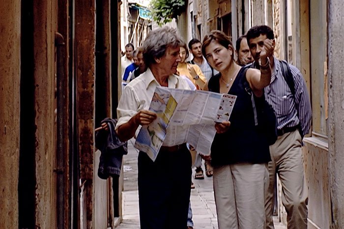 Justine getting directions from a local holding a map