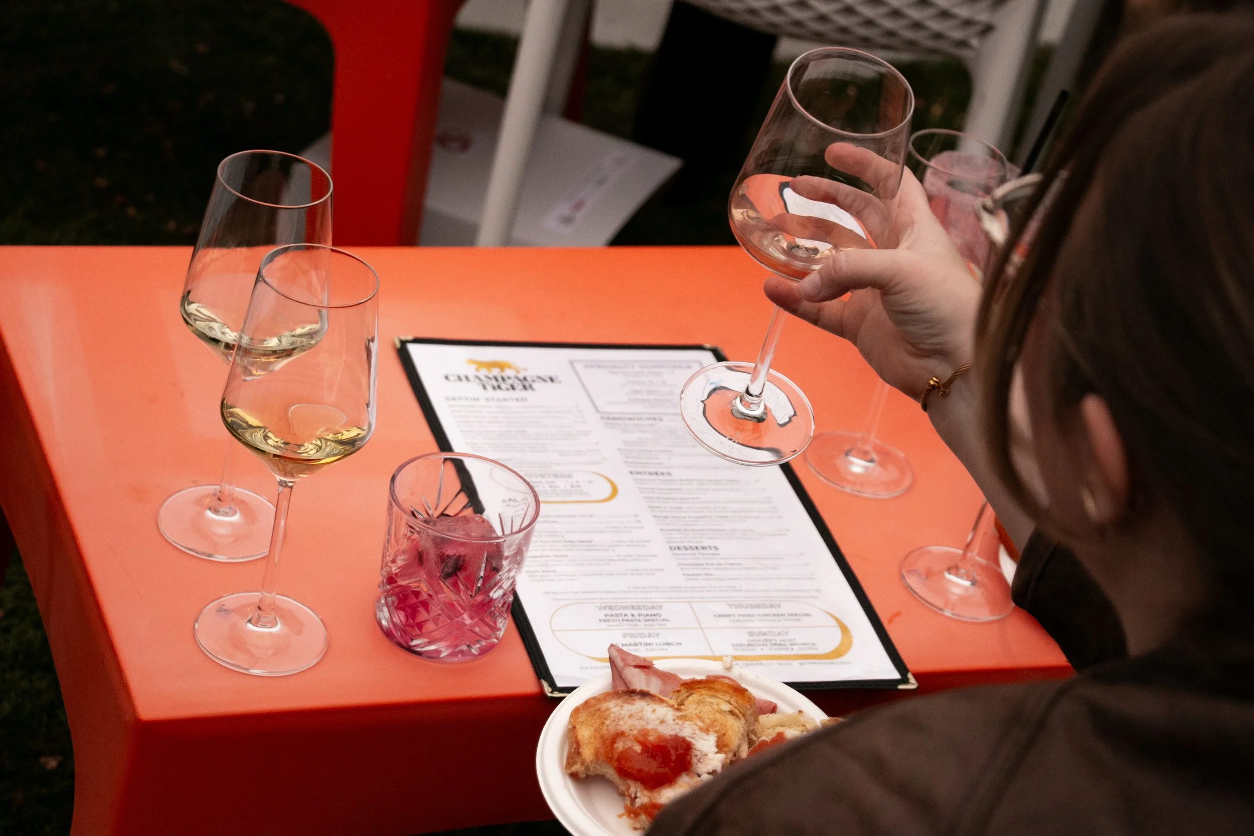 Champagne Tiger menu and wine glasses at Developing Denver's flight and fight event